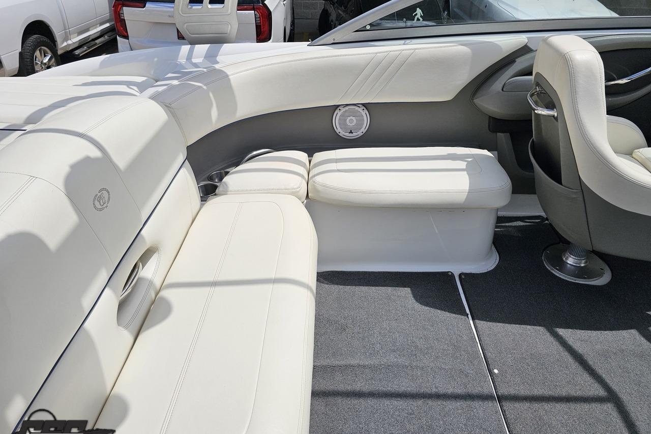 Interior of a 2010 Cobalt 232 WSS boat with white leather seating and speaker.