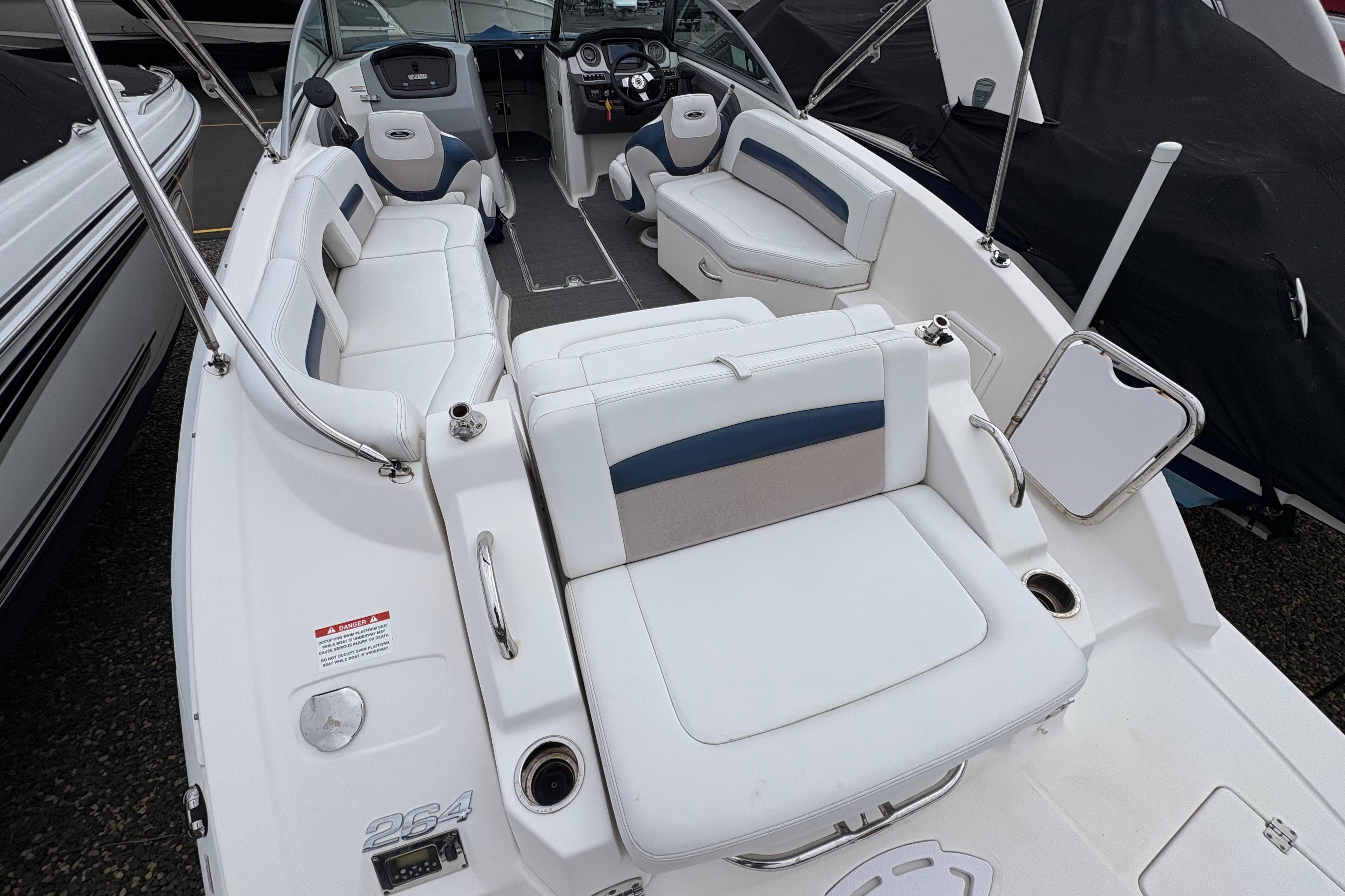 2015 Chaparral 264 Sunesta boat interior with white seating and modern dashboard.