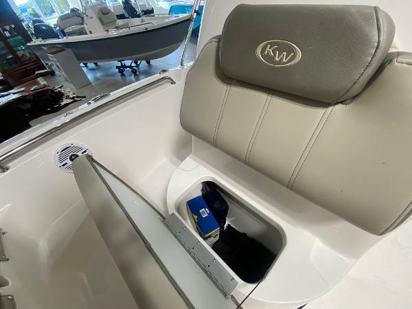 2024 Key West 189 FS boat seat with storage compartment open.