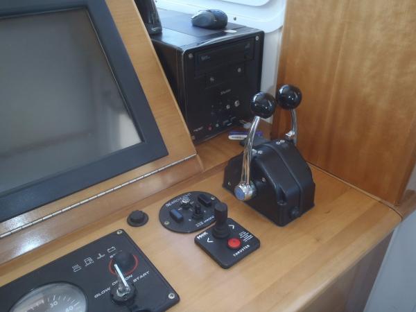 Control panel of 2025 Great Harbour N40 boat with throttle levers and navigation screen.