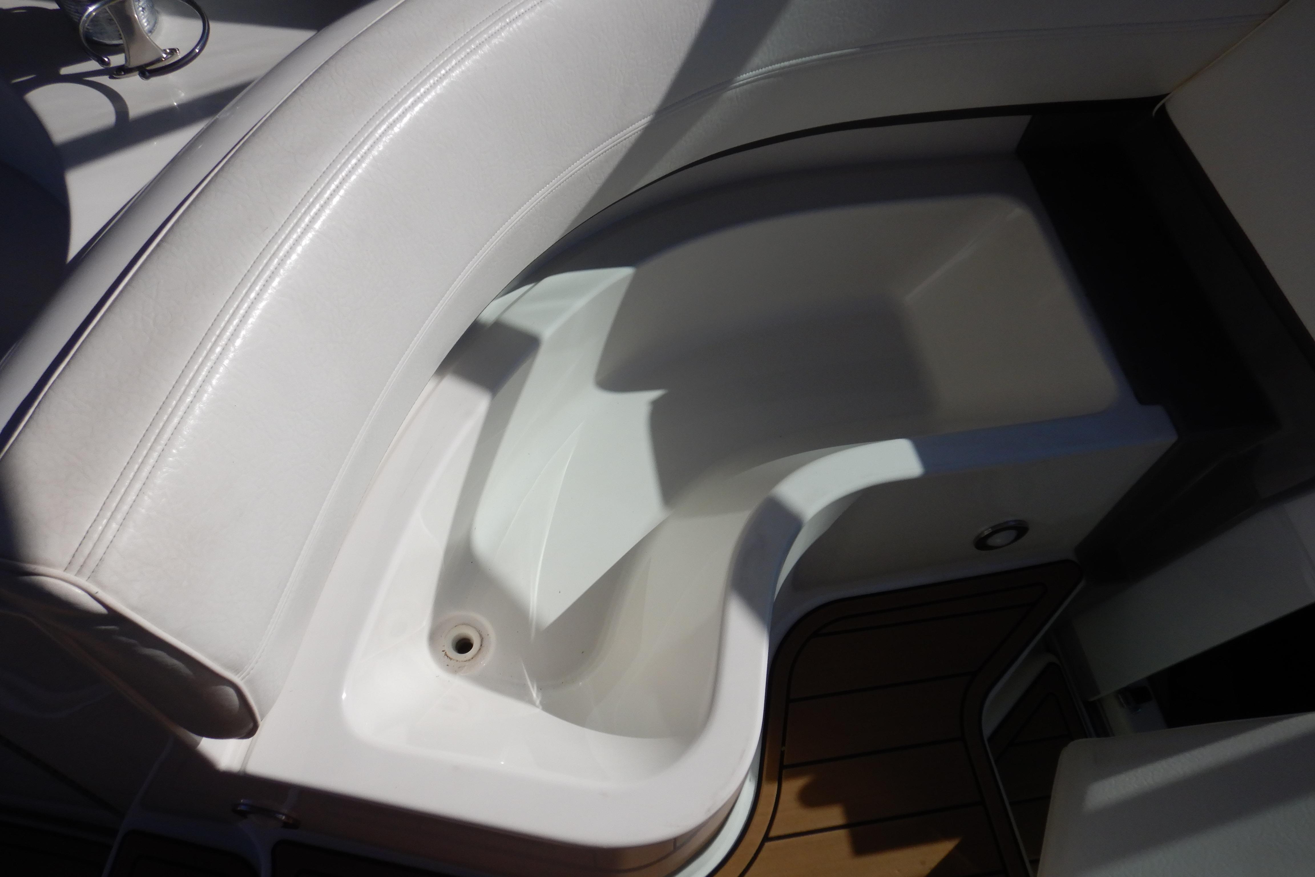 2007 Cruisers 340 Express boat interior seating with white upholstery and wooden flooring.