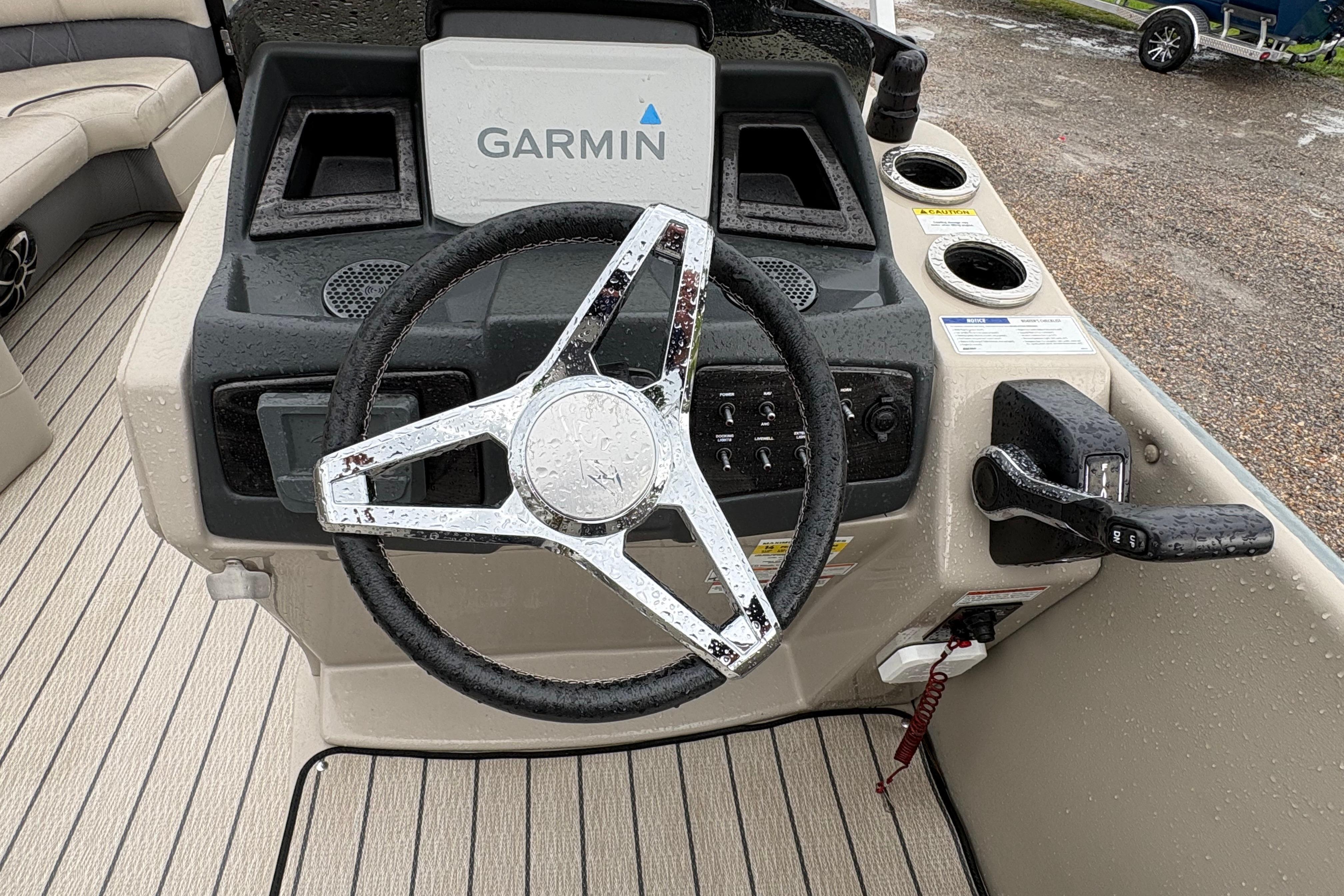 2023 SilverWave 2410 CLS boat dashboard with Garmin navigation system and steering wheel.