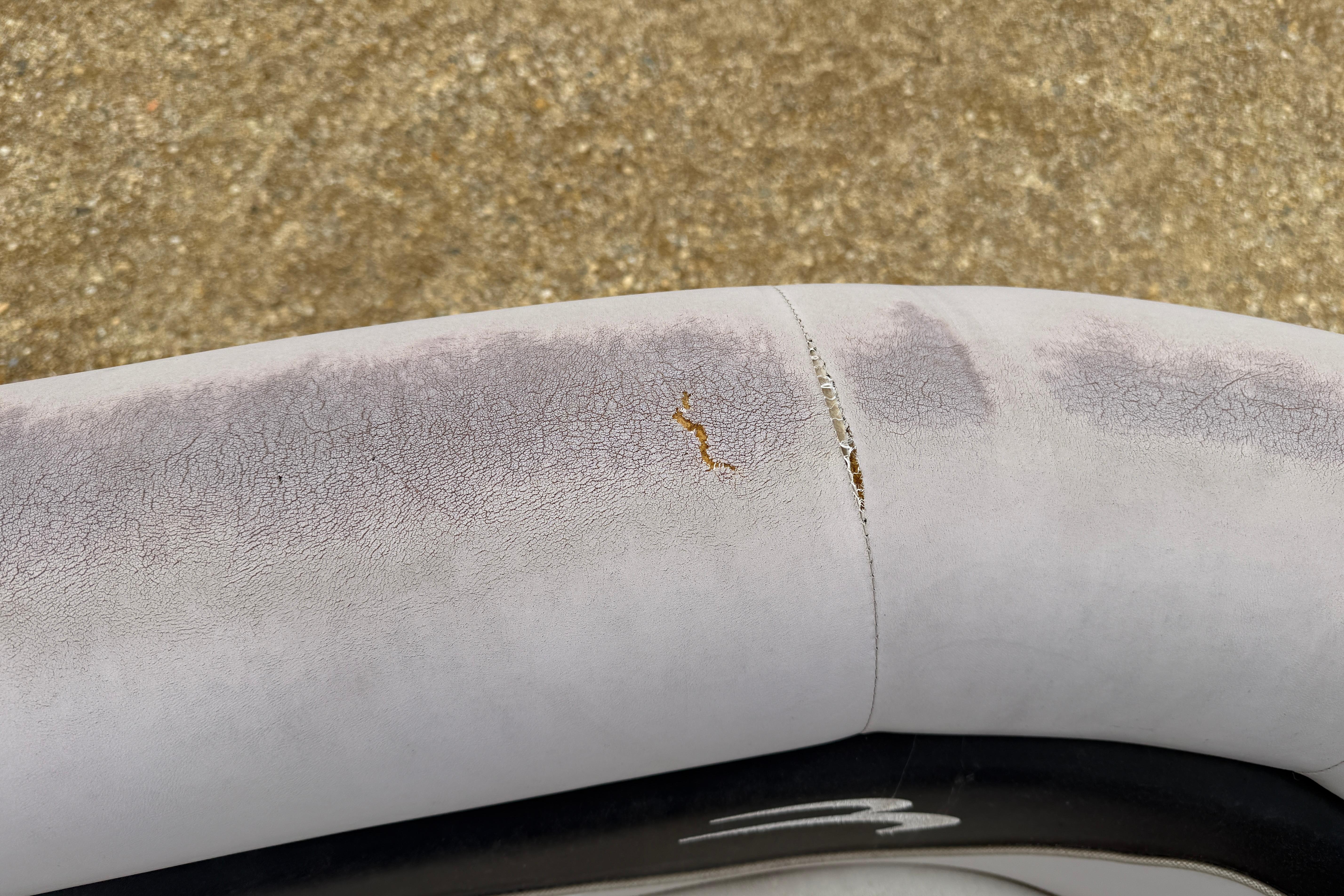 Cracked upholstery on 2010 Bennington 20SLi boat seat, showing wear and tear.