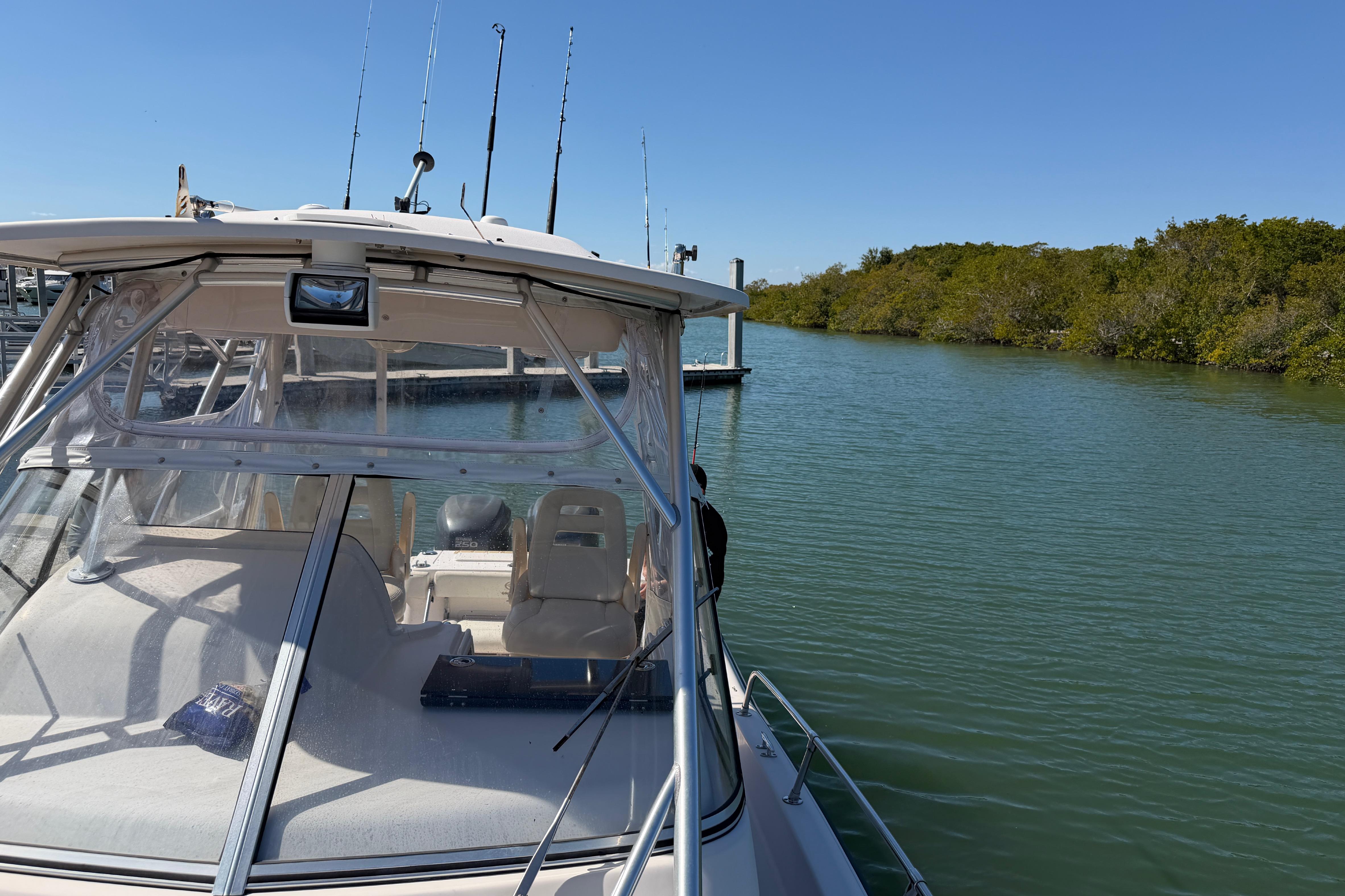 2006 Grady-White Sailfish 282 boat docked on calm water, clear sky background.