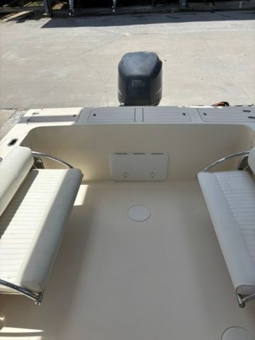 The image shows the stern of a Parker 2310 Walkaround boat with two cushioned benches.