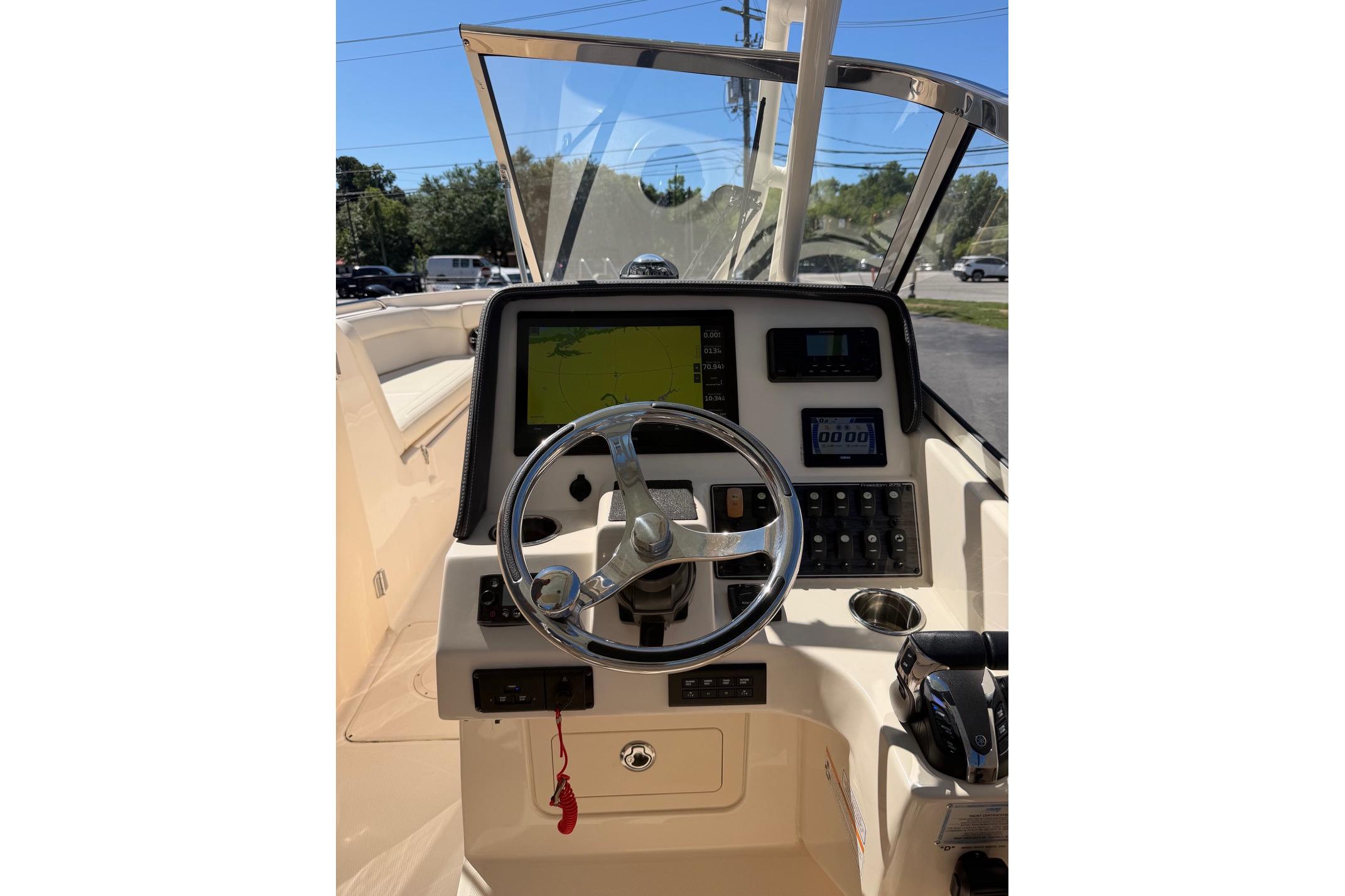 2022 Grady-White Freedom 275 boat dashboard with steering wheel and navigation controls.