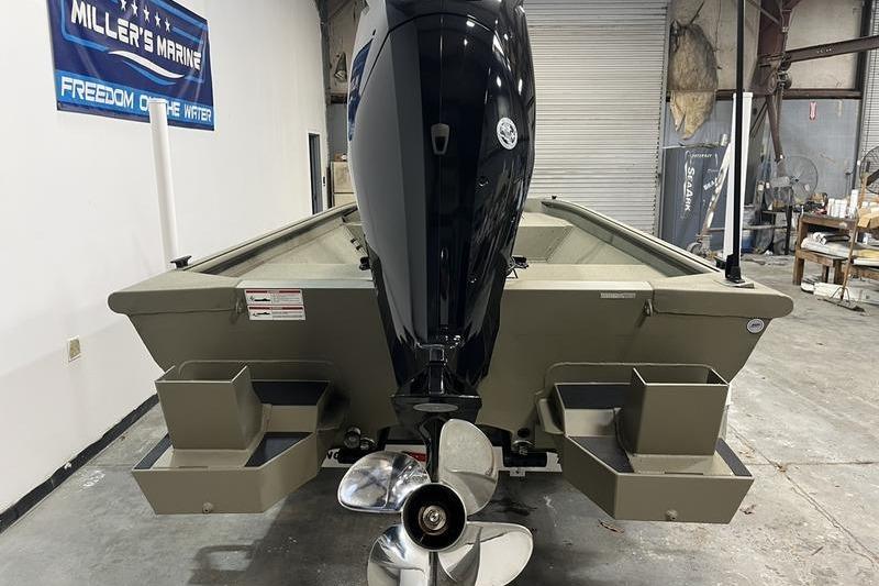 2025 SeaArk Shadow 18T boat with outboard motor in a garage setting.