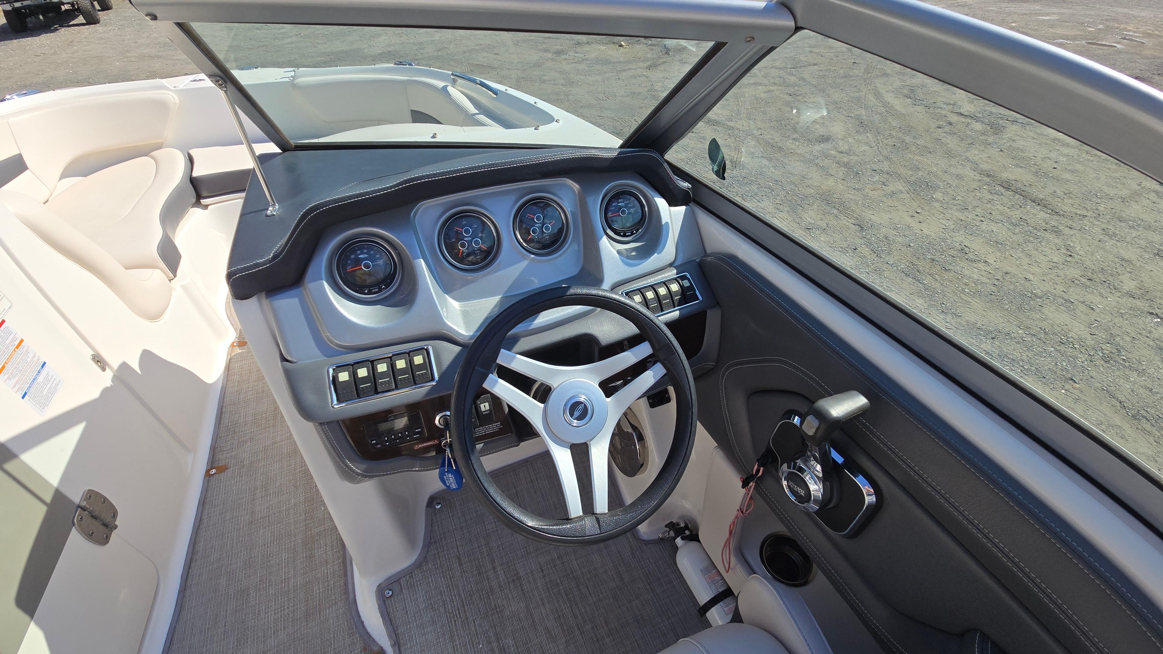 2018 Chaparral 224 Sunesta boat dashboard with steering wheel and gauges.