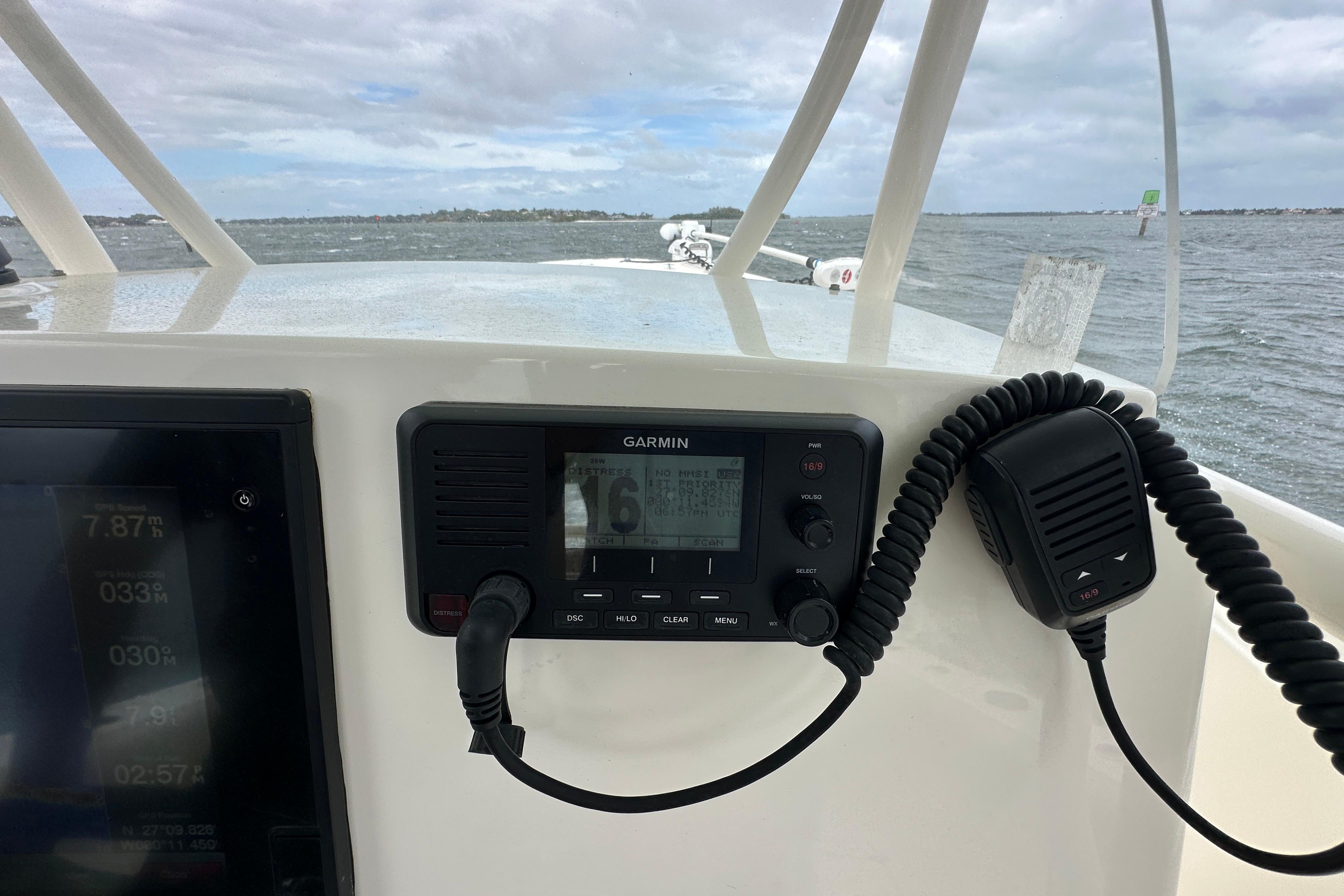 2016 Cobia 277 Center Console boat dashboard with Garmin marine radio and ocean view.