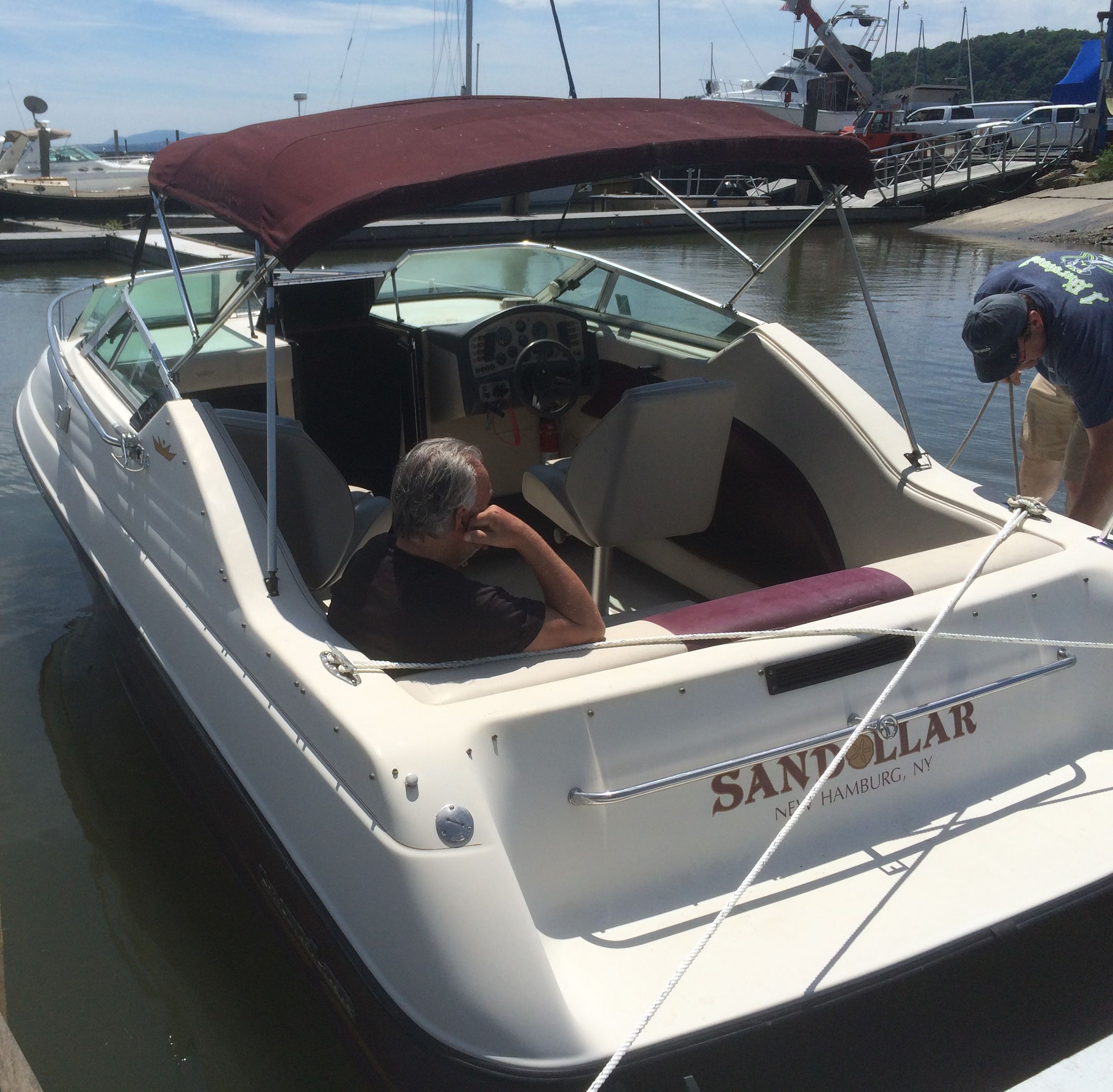 A 1992 Crownline Cudy Cruser docked. Two people are on board.