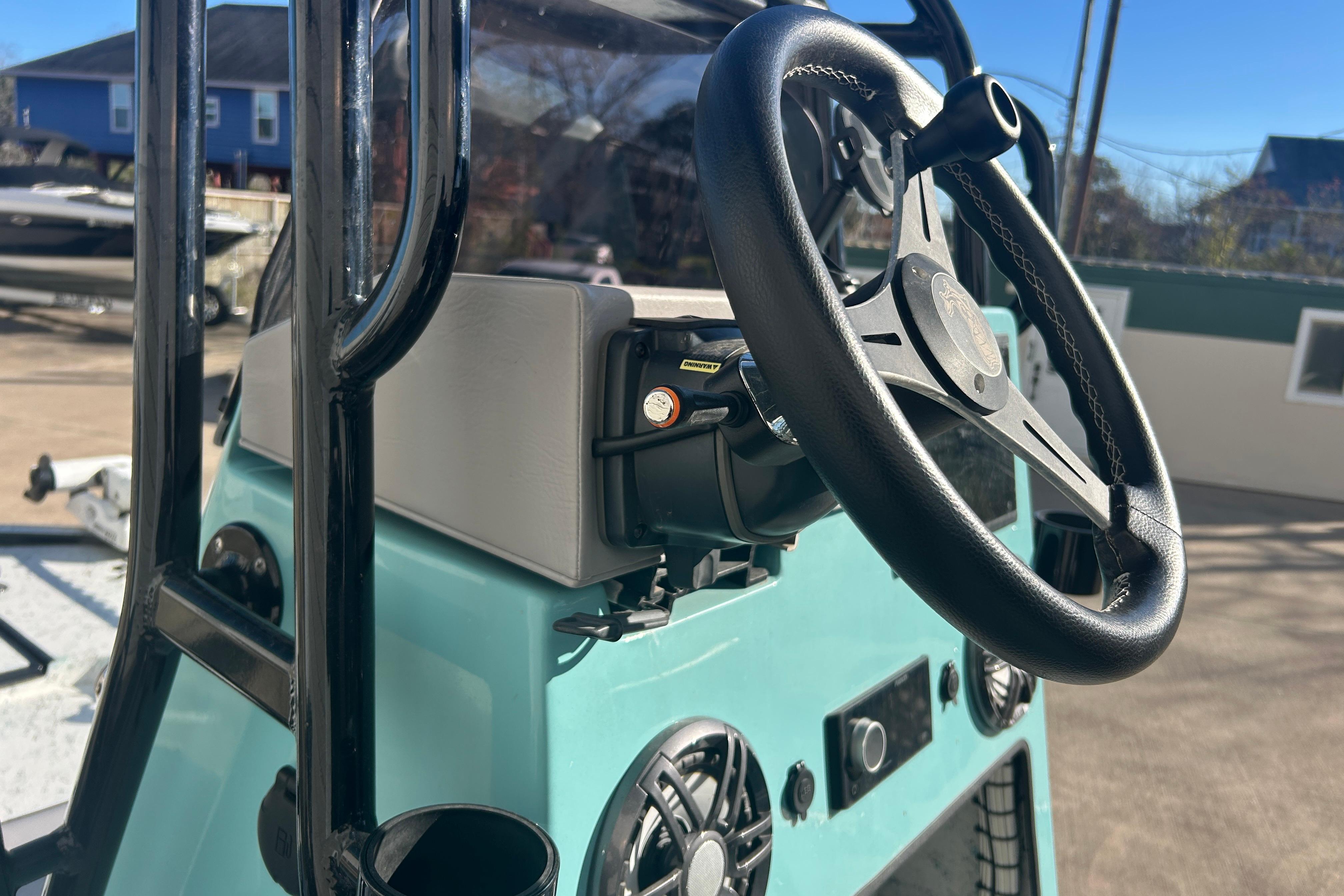 2021 Shallow Stalker Cat 240 Pro Elite steering console with black wheel and controls.