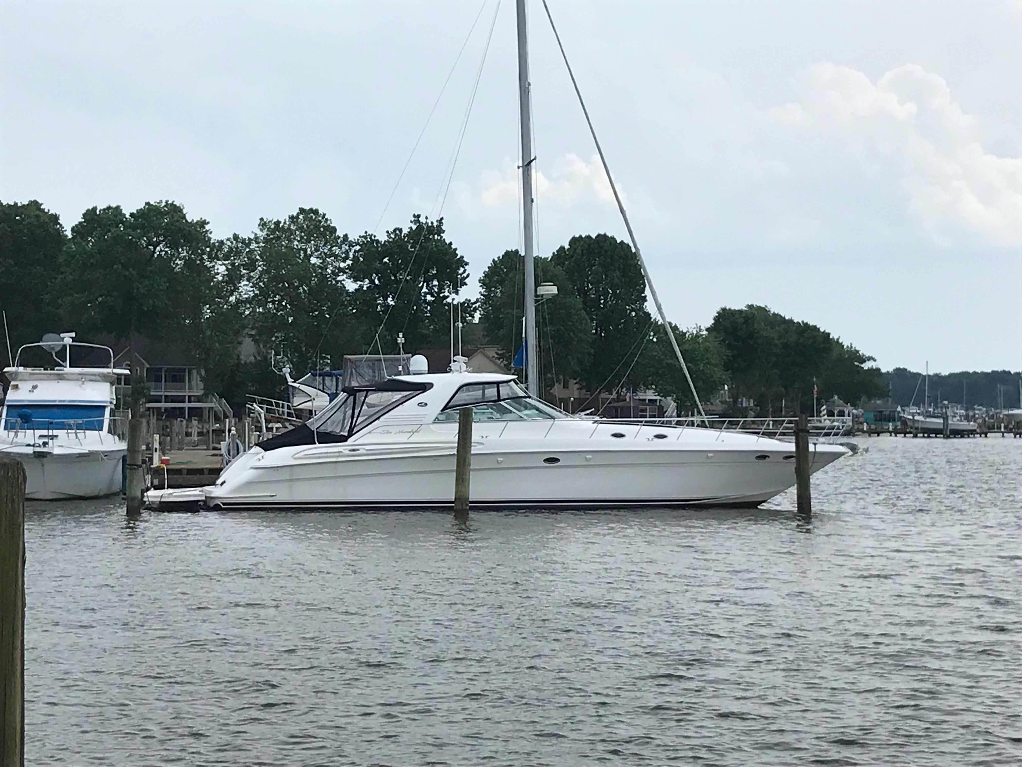 A 2003 Sea Ray S600 Sunsport docked in a calm marina.