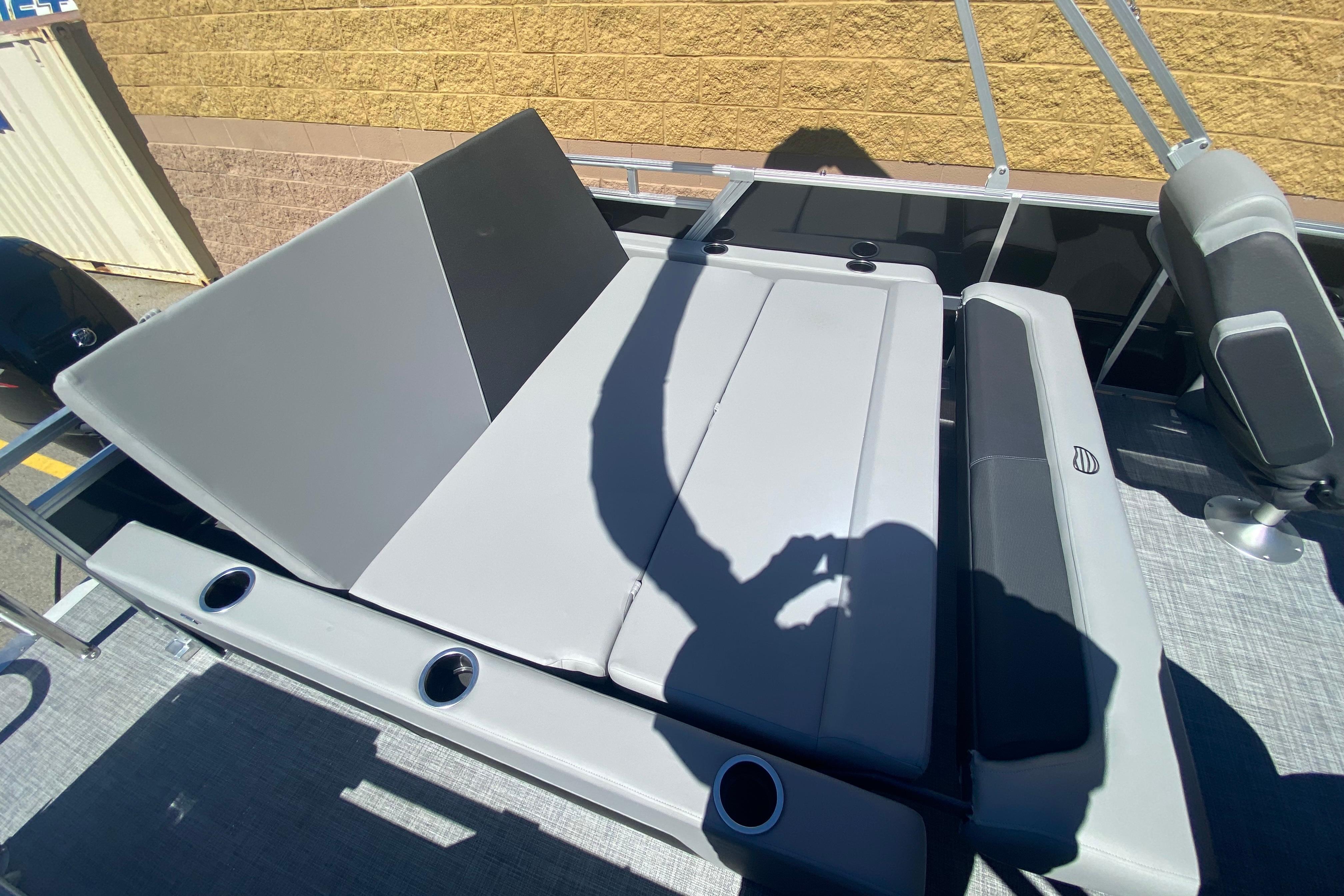 2026 Sun Tracker Party Barge 22 RF DLX with gray seating and cup holders.