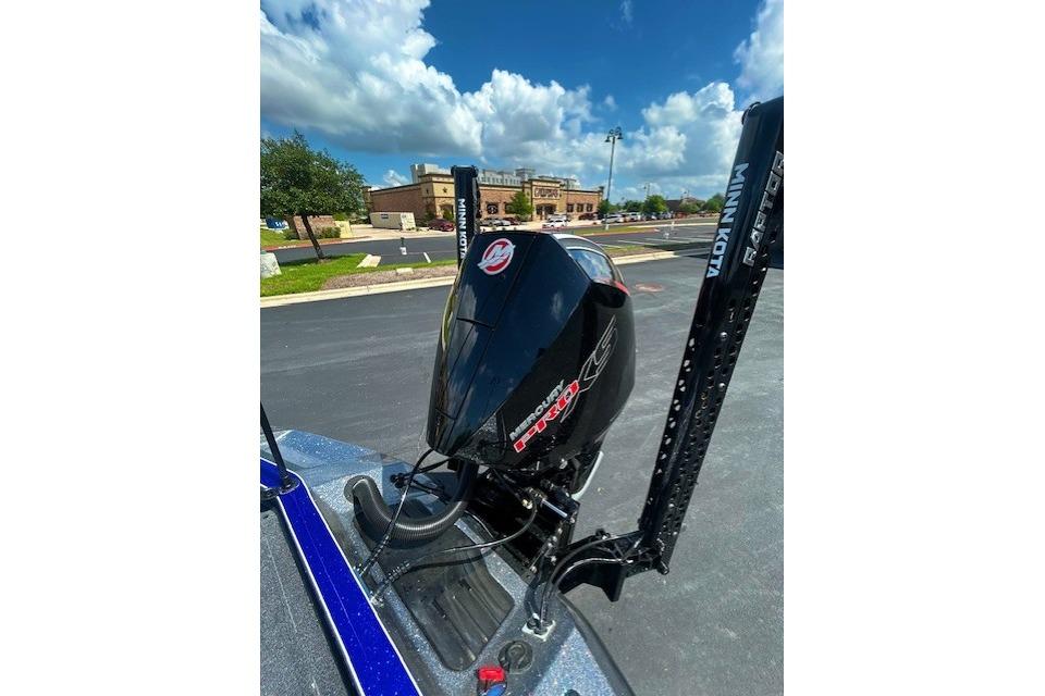 2026 Ranger Z521 boat with Mercury engine and Minn Kota trolling motor in parking lot.