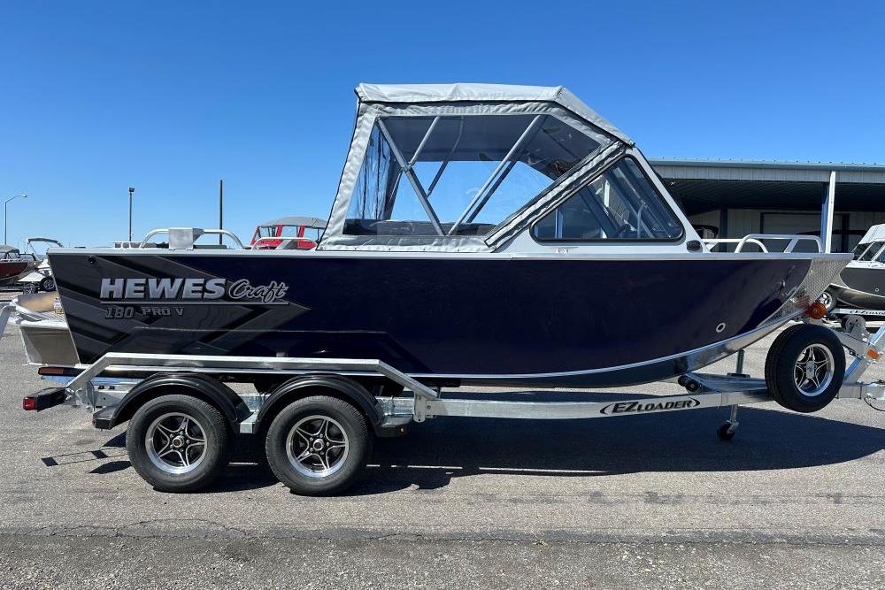 2026 Hewescraft 180 ProV ET boat on trailer under clear blue sky.