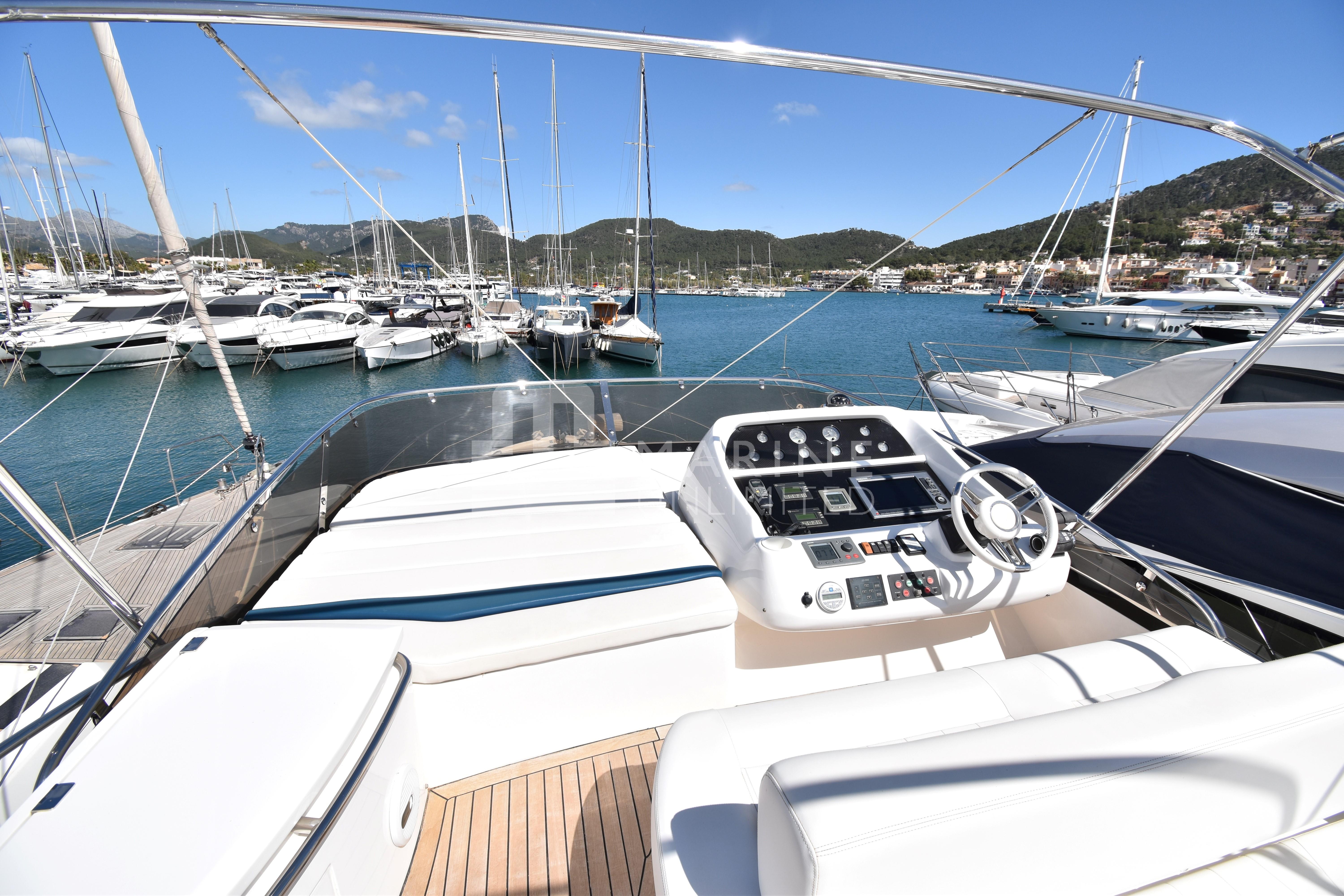 2010 Sunseeker Manhattan 52 yacht, docked in a marina with scenic mountain views.