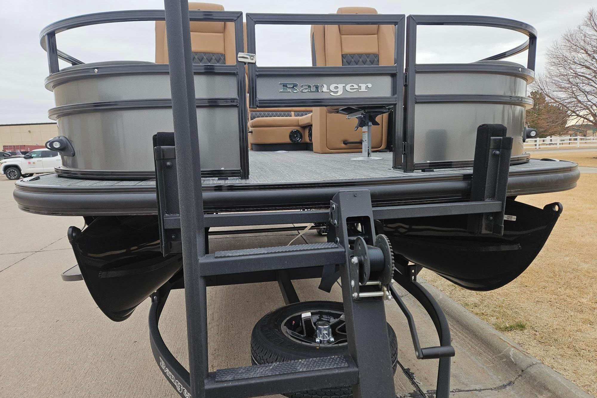 2026 Ranger 220F pontoon boat on trailer, featuring sleek design and comfortable seating.