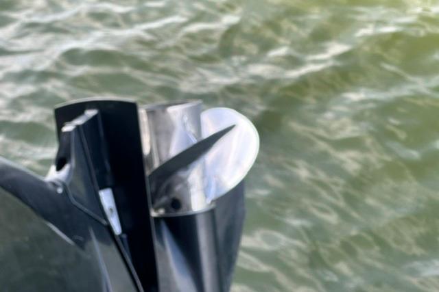 Propeller of 2019 Sun Tracker Party Barge 22 XP3 on water background.