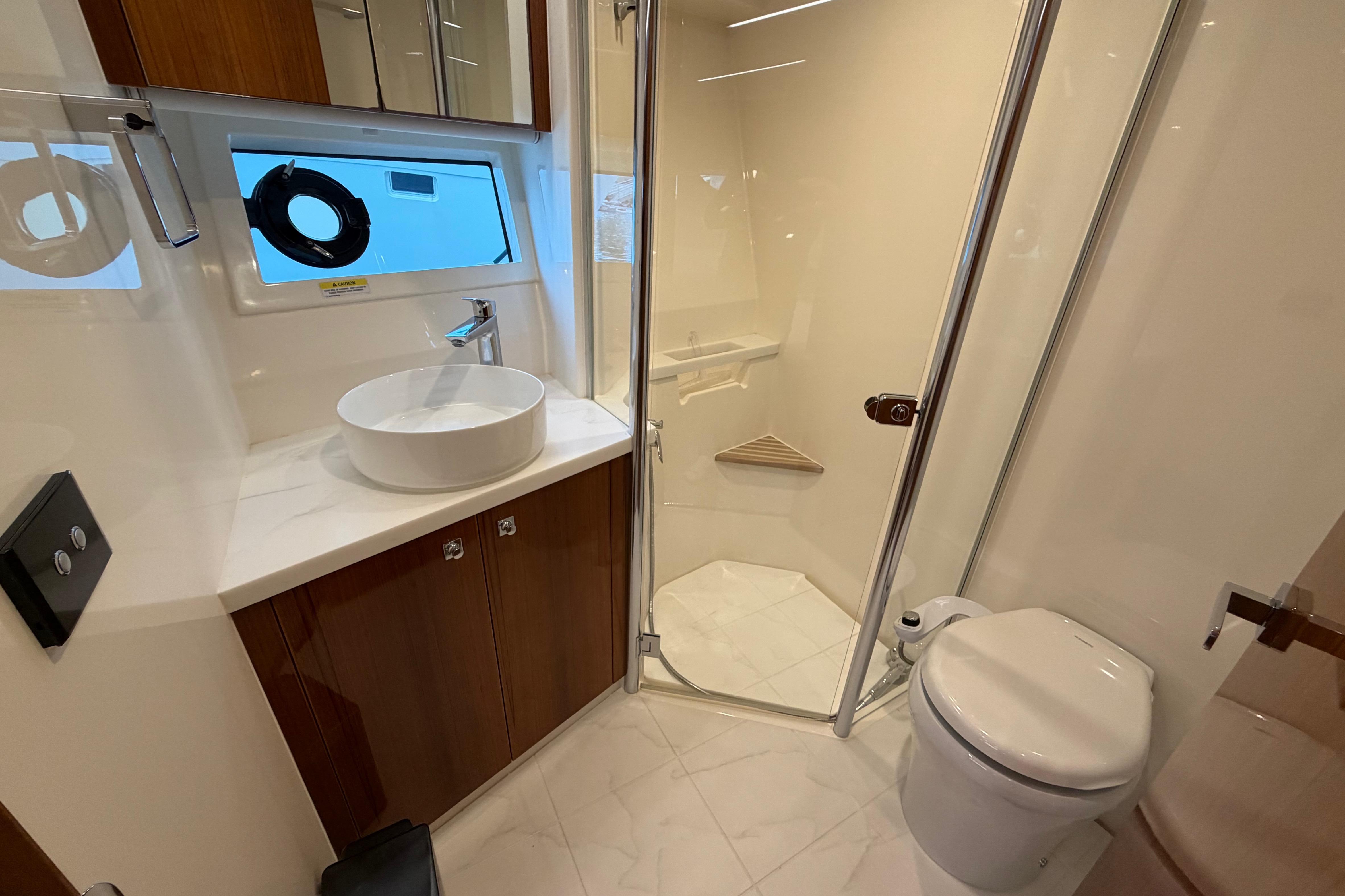 Luxurious bathroom in 2023 Riviera 645 SUV yacht with modern fixtures and elegant design.