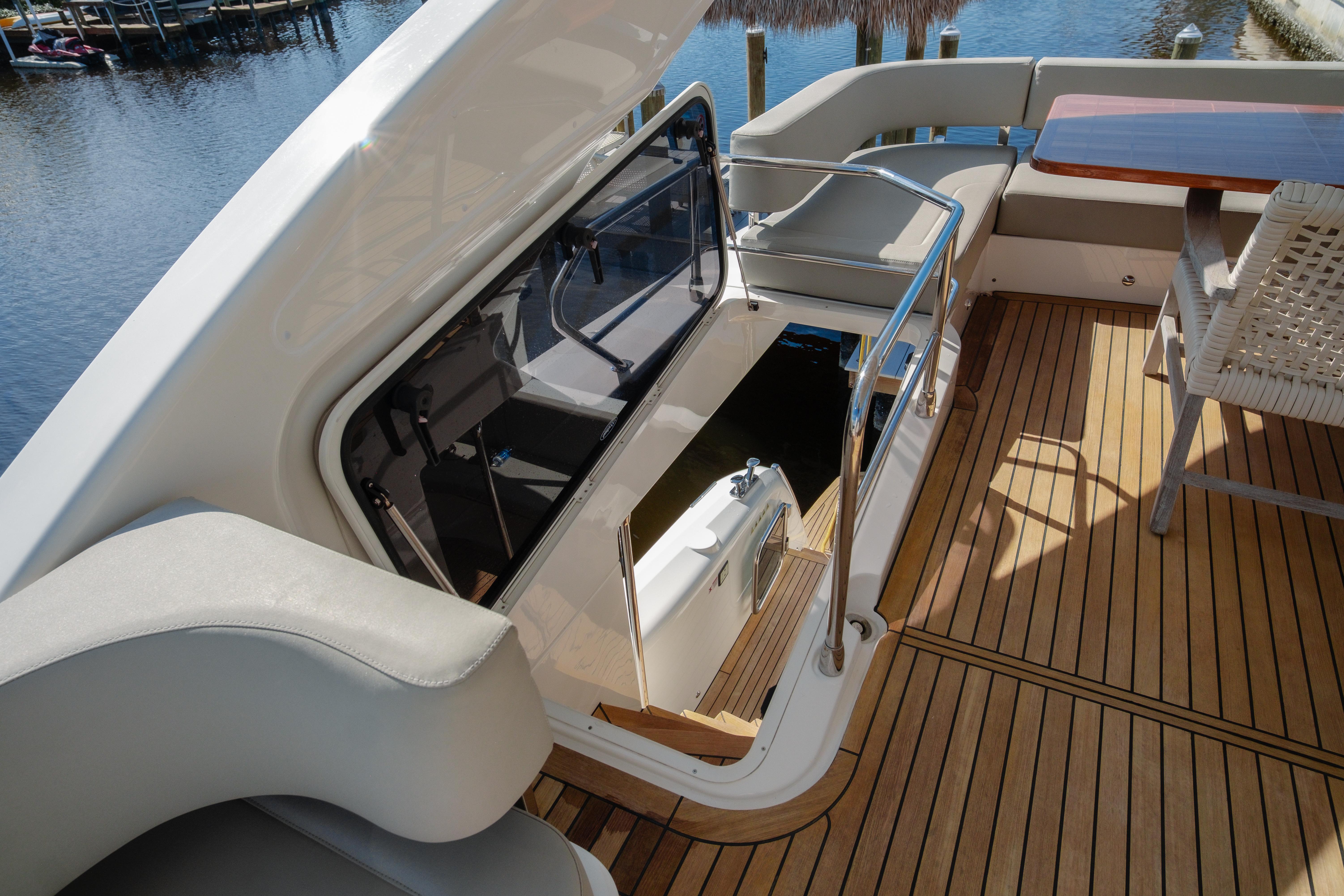 2020 Absolute 48 Navetta yacht deck with seating and wooden flooring.