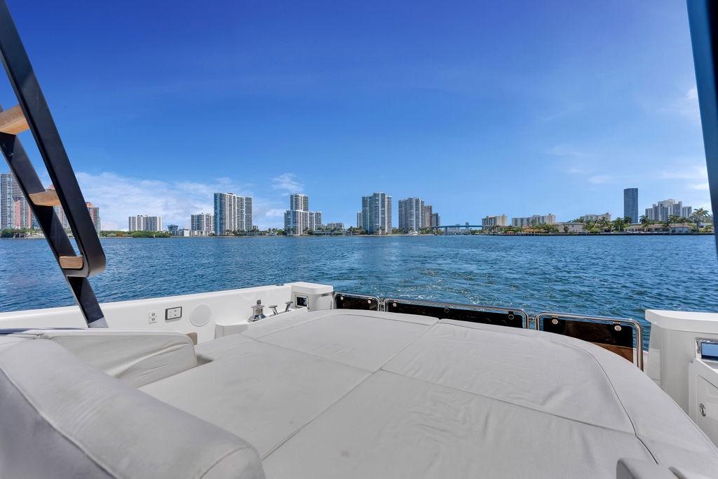 Luxury view from 2021 Bluegame BG 42 yacht, overlooking city skyline and calm waters.
