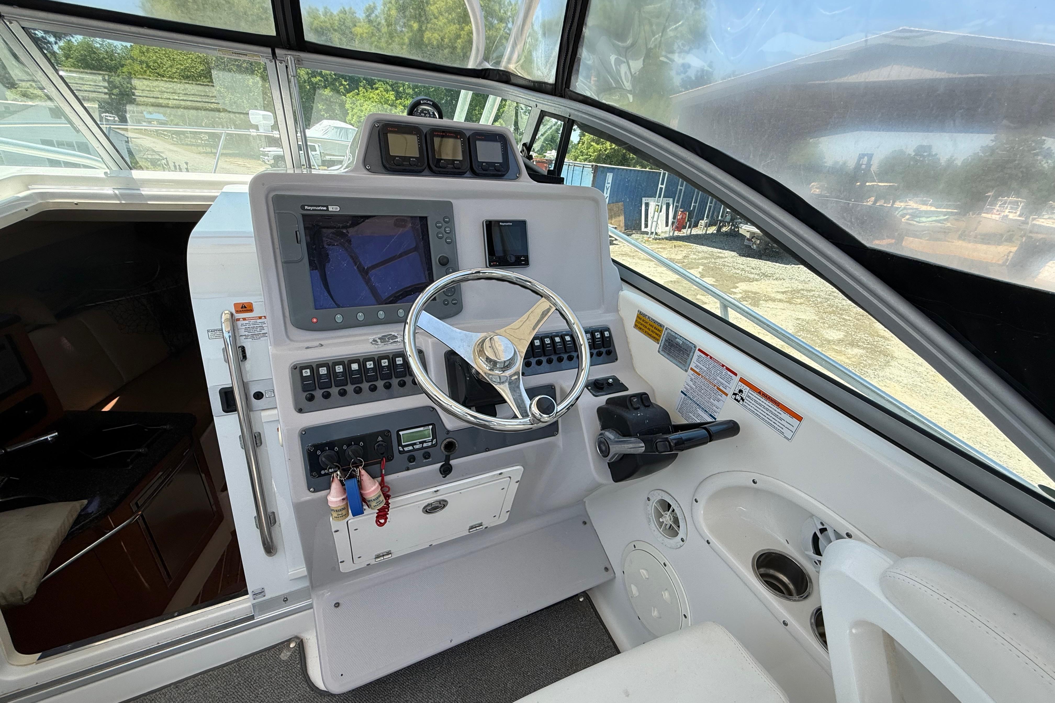 2007 Robalo R305 Walkaround helm with steering wheel and navigation controls.