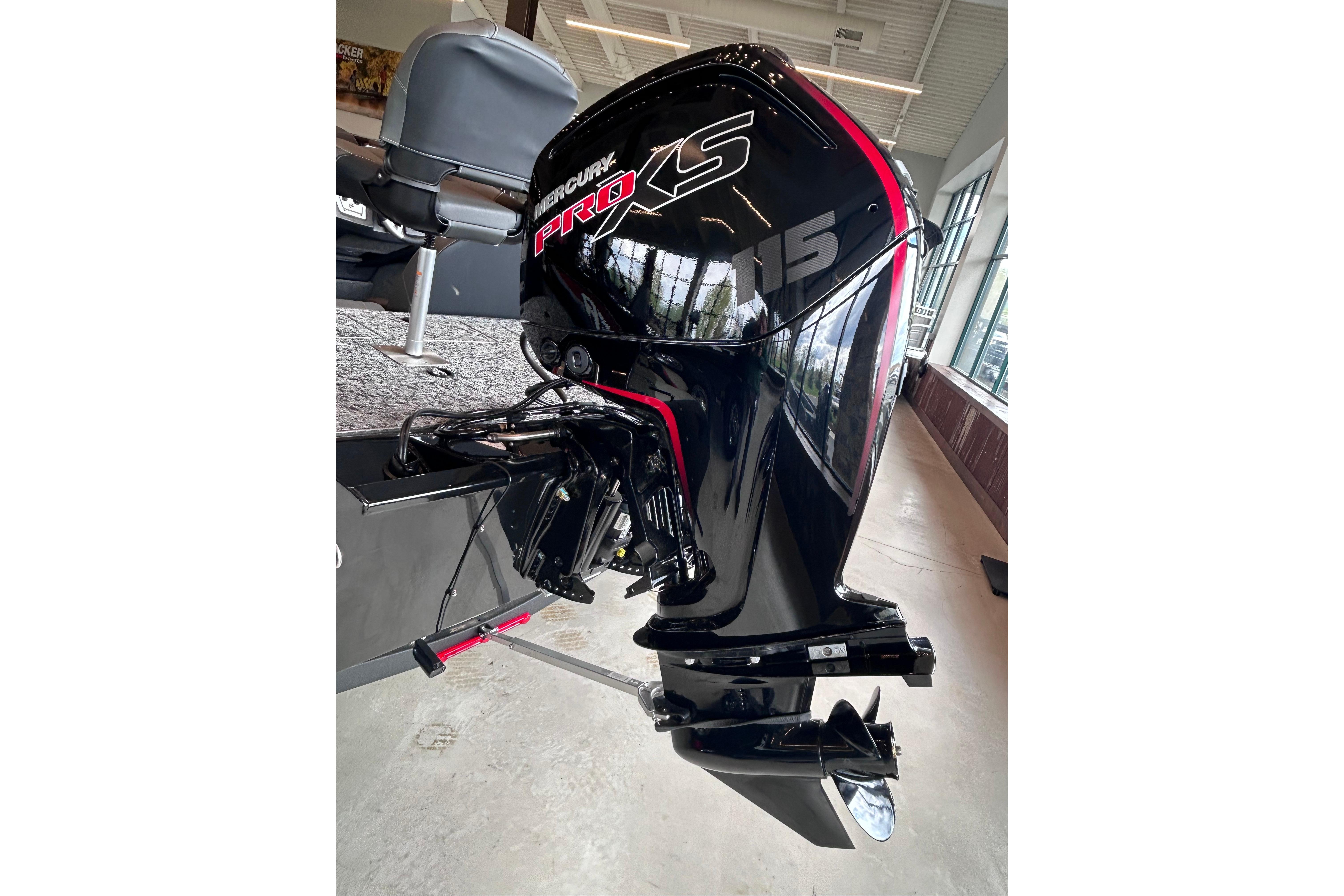2026 Tracker Pro Team 195 boat with Mercury Pro XS outboard motor in showroom.