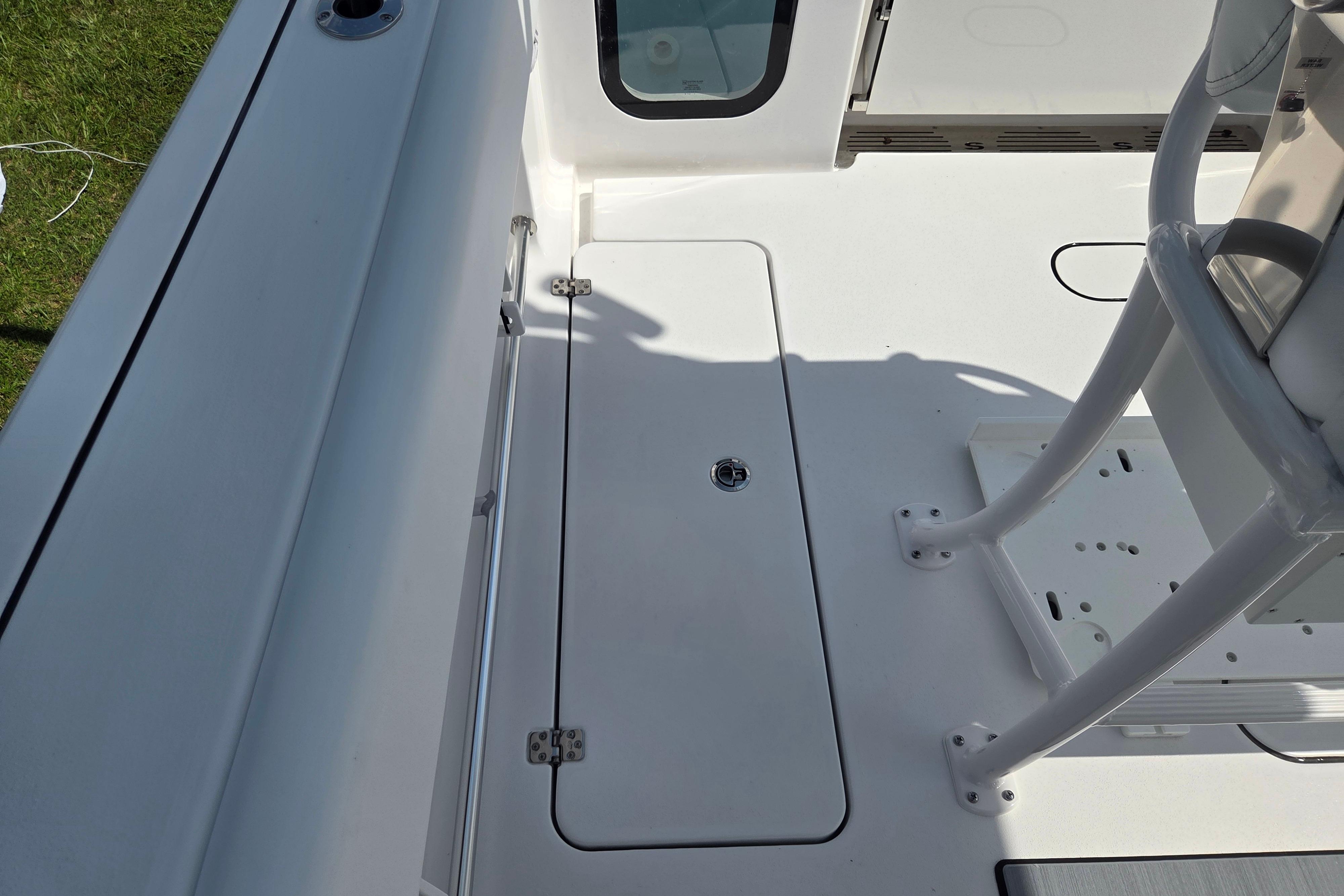 2026 Sportsman Open 252 Center Console boat deck with storage compartment.