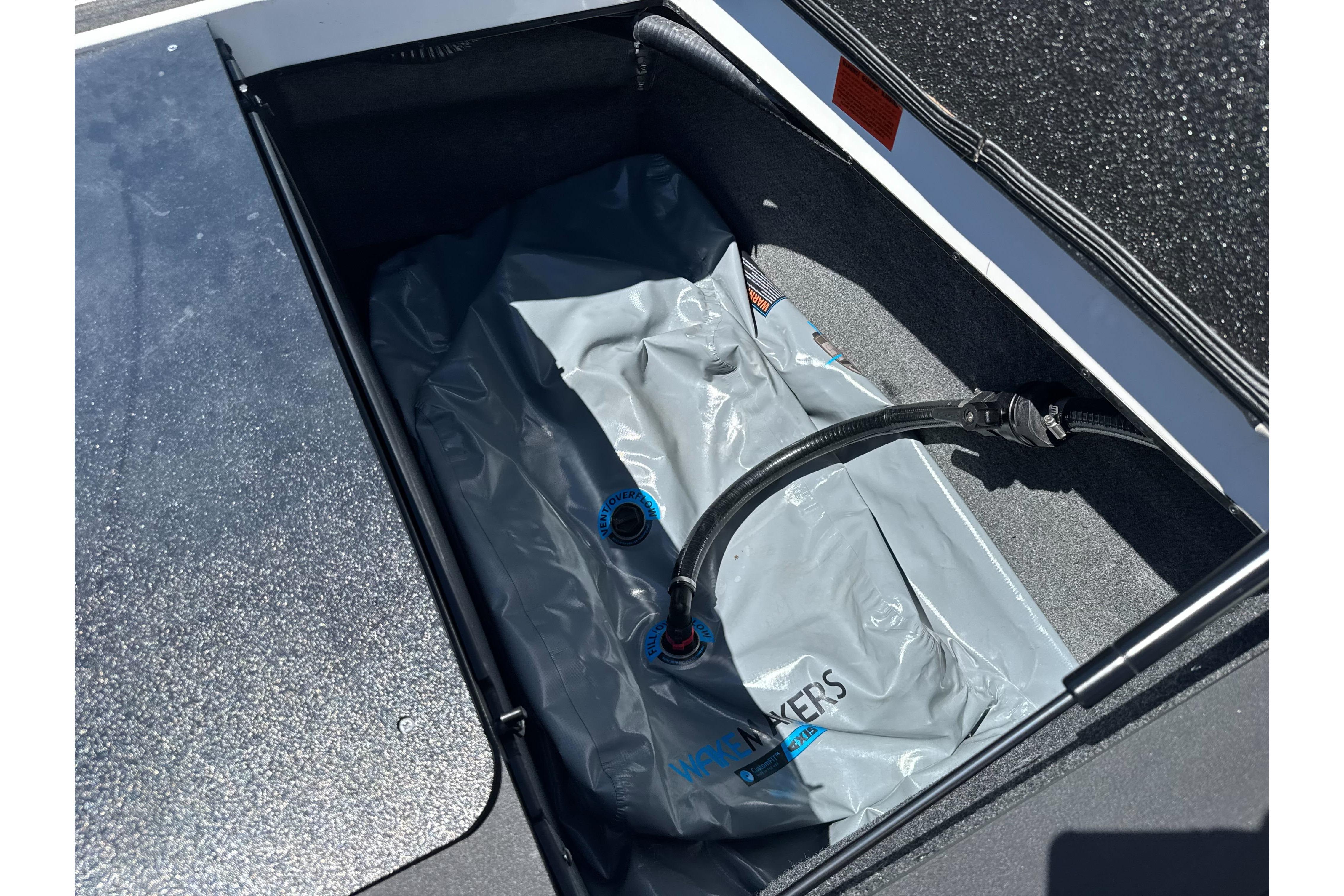 2015 Axis A20 boat storage compartment with ballast bag and hose.
