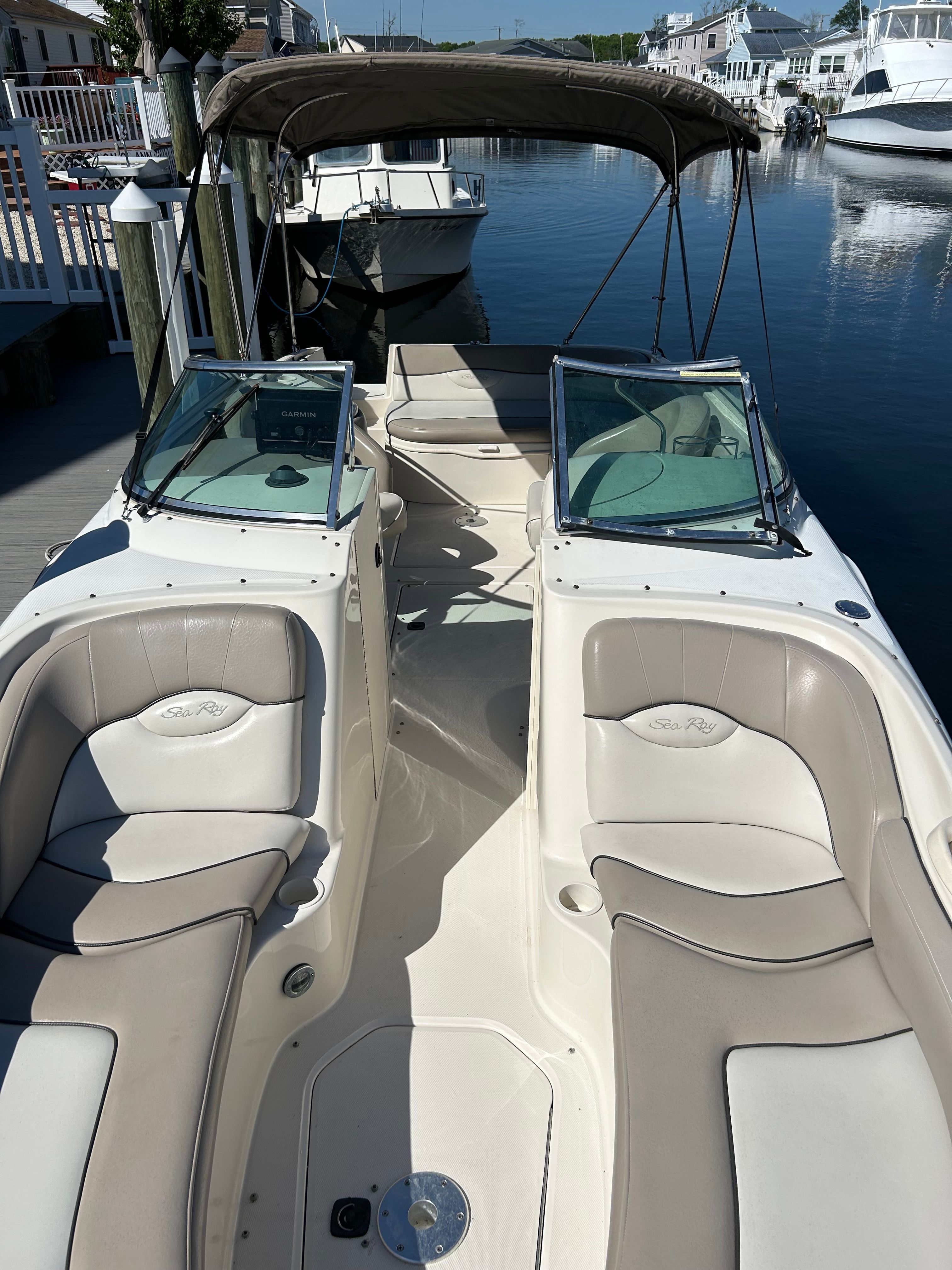 2003 Sea Ray 240 Sundeck boat docked in marina.