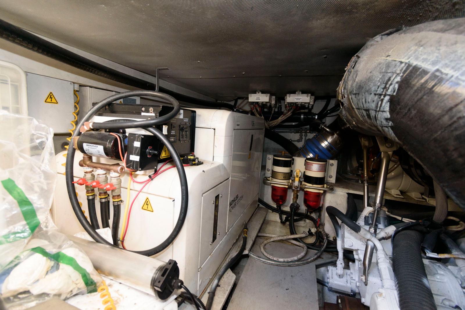 Engine room of 2005 Azimut 50 Flybridge yacht, showcasing mechanical components and wiring.