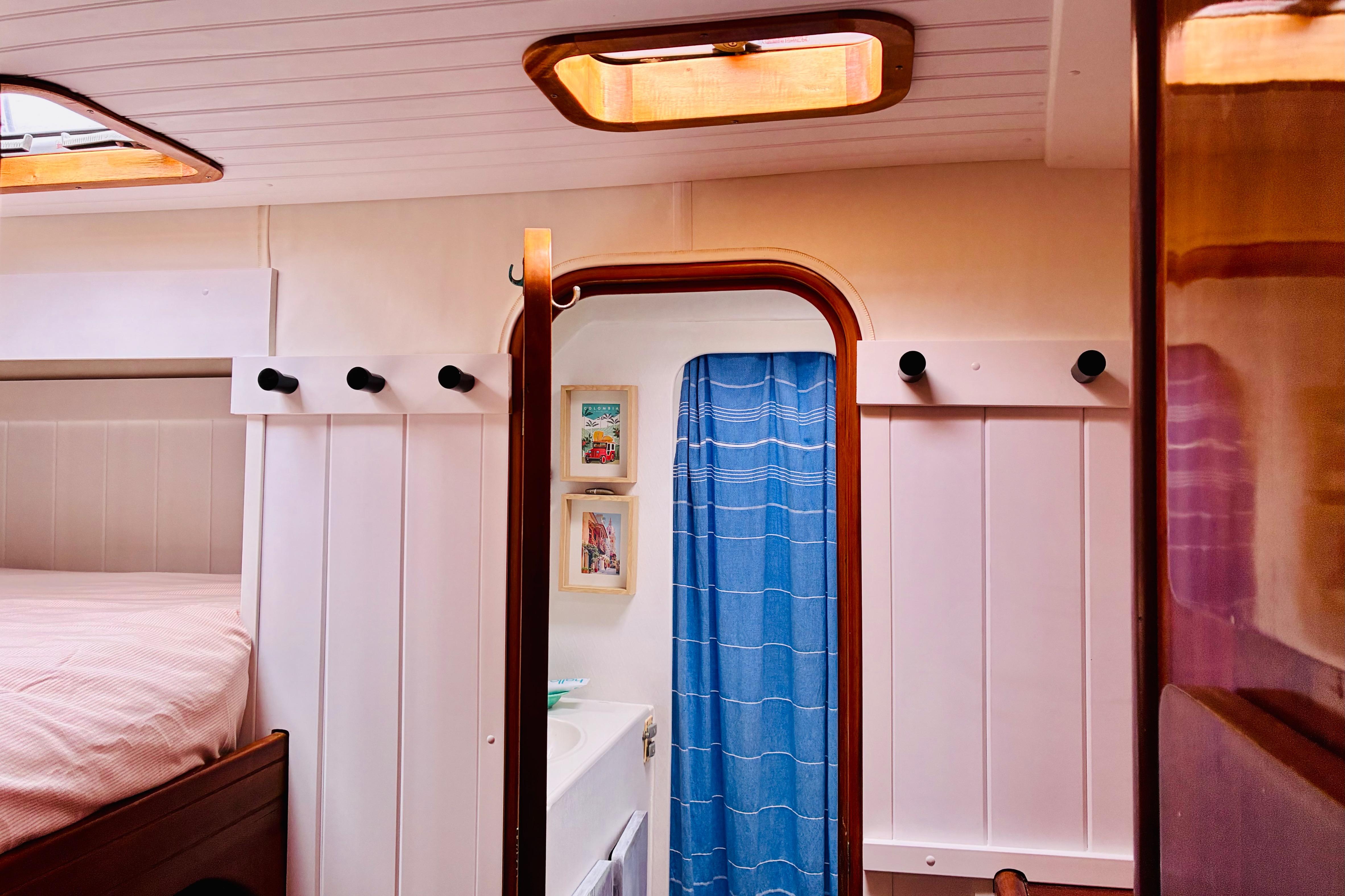 Interior of 1992 Privilege 482 yacht with cozy cabin and blue curtain.