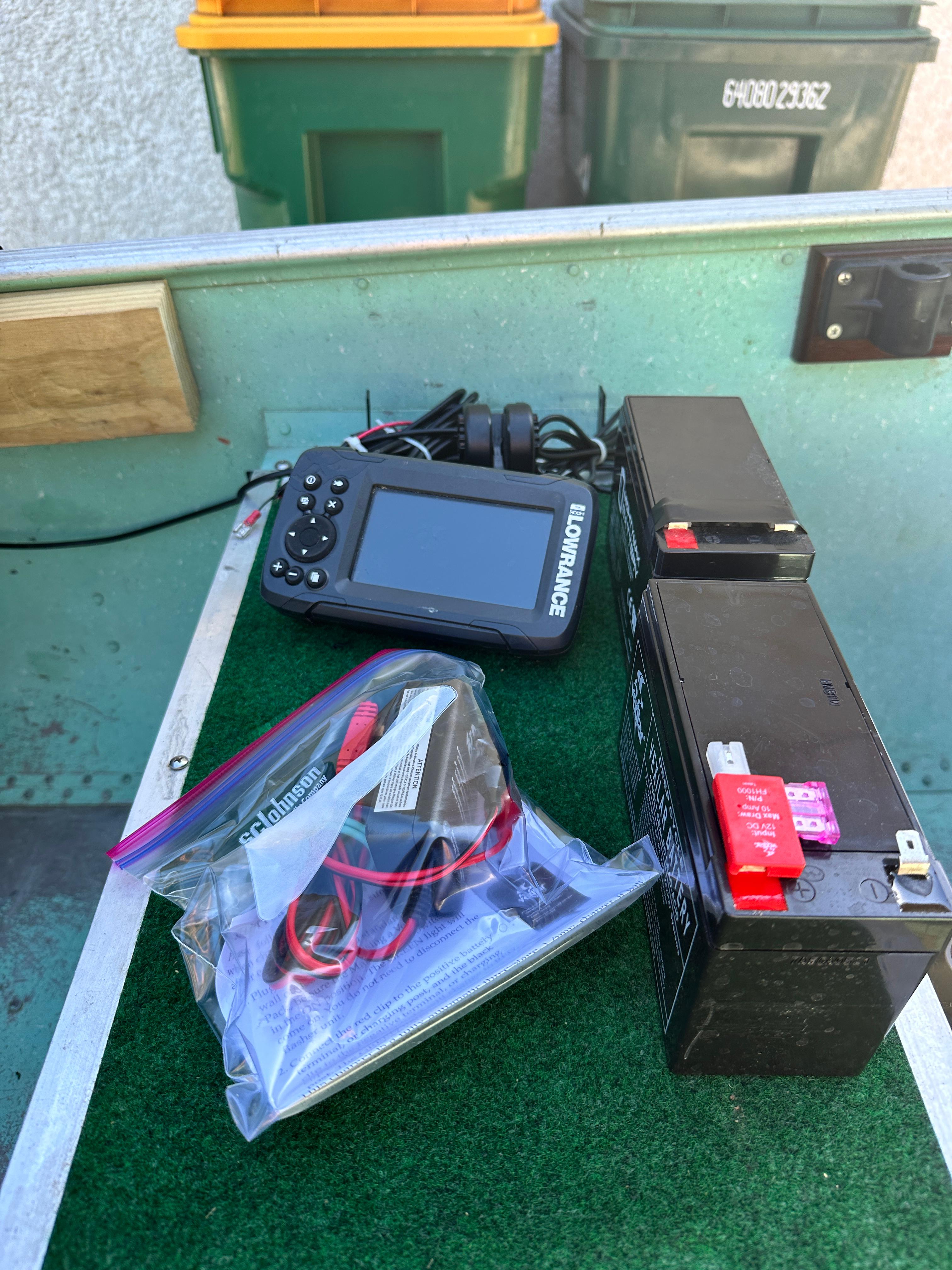 Boat equipment setup with Lowrance device and battery on Lund H, 1960 model.