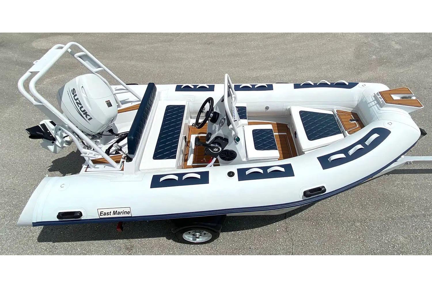 Manufacturer Provided Image: 2025 East Marine 420 inflatable boat with Suzuki outboard motor, featuring sleek design and seating.