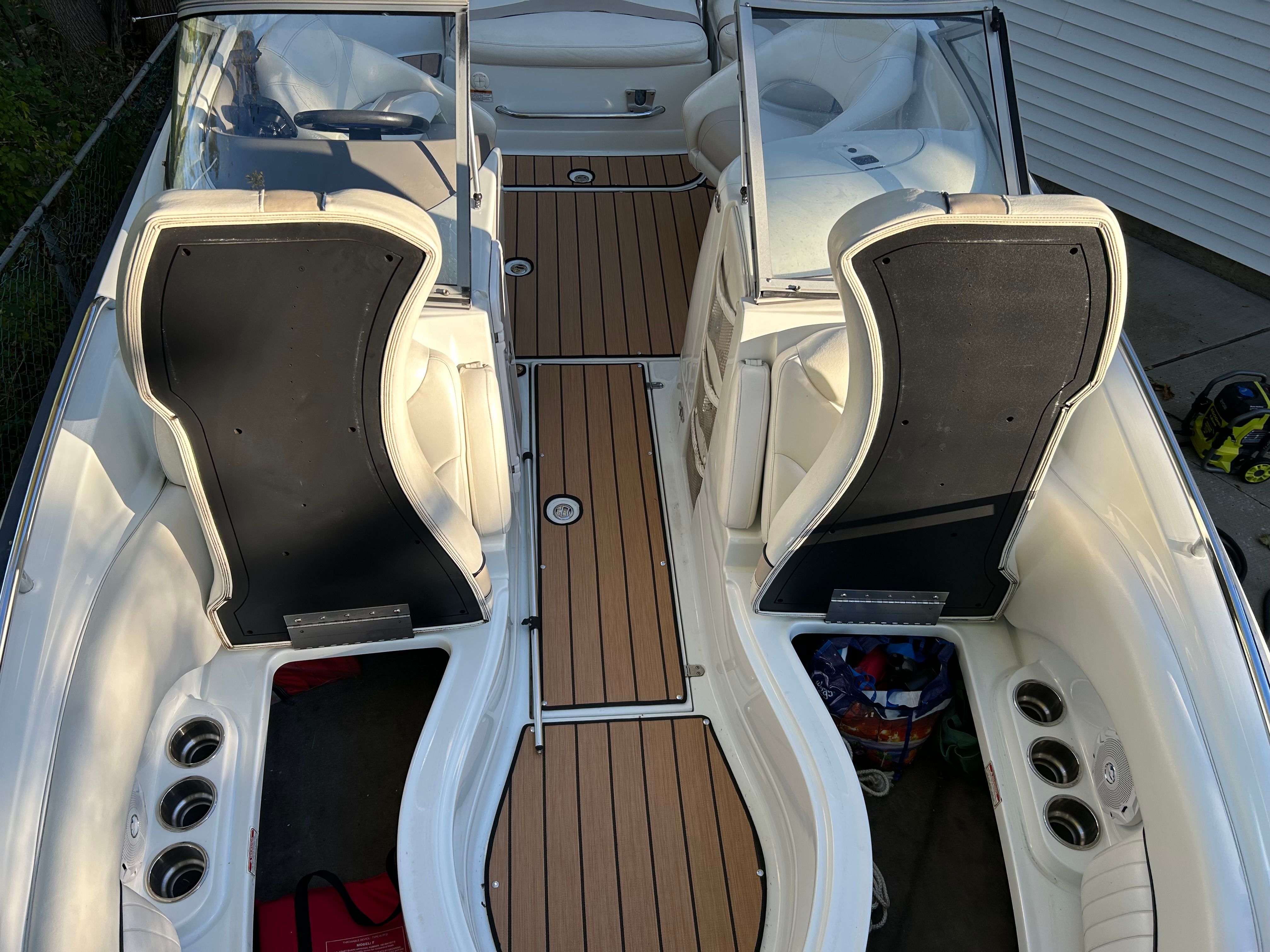 The image shows the cockpit of a 2008 Azure AZ220 boat with sleek seating and wood flooring.