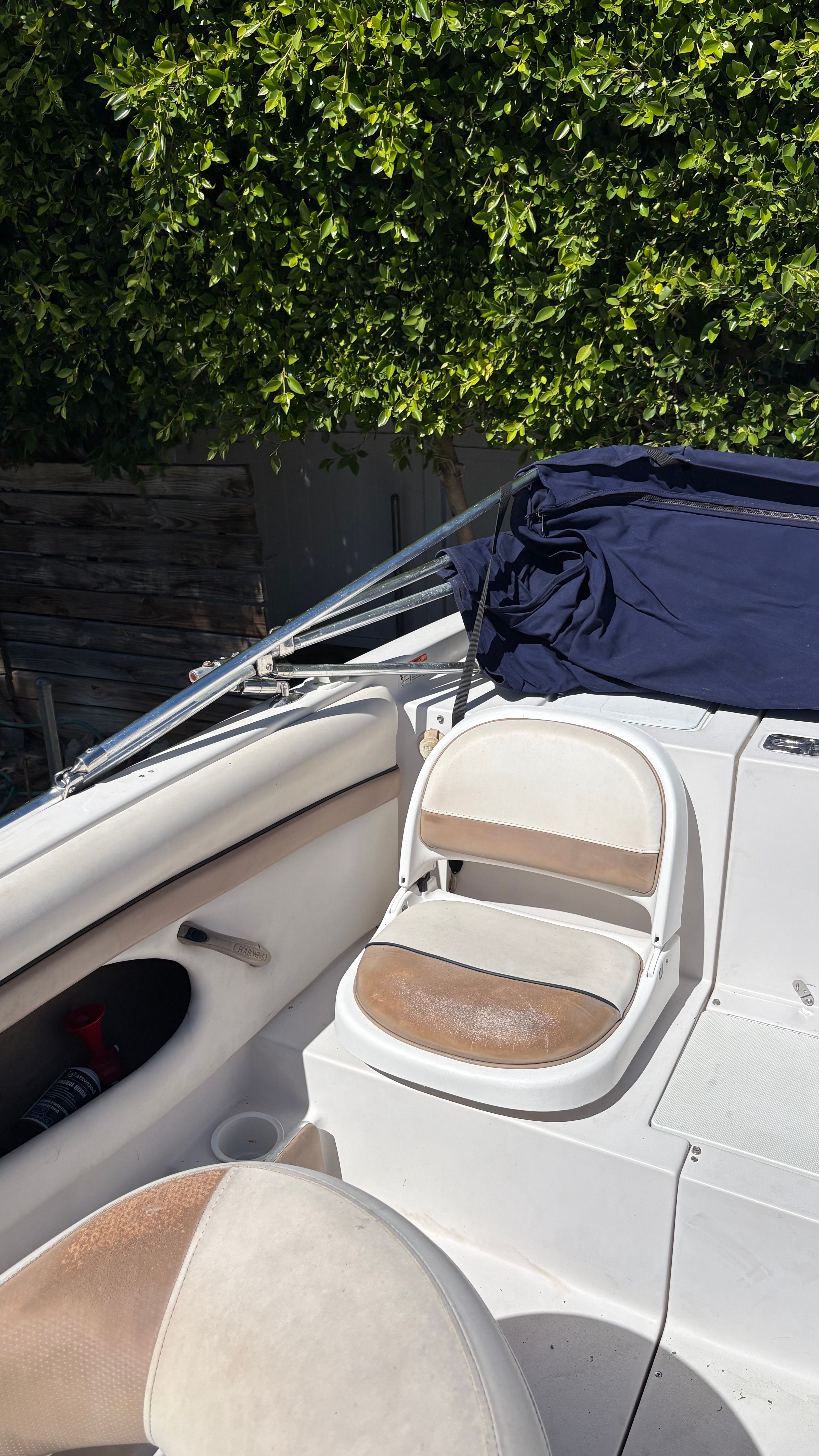 2007 Four Winns 203 Horizon boat with seating area and canopy.