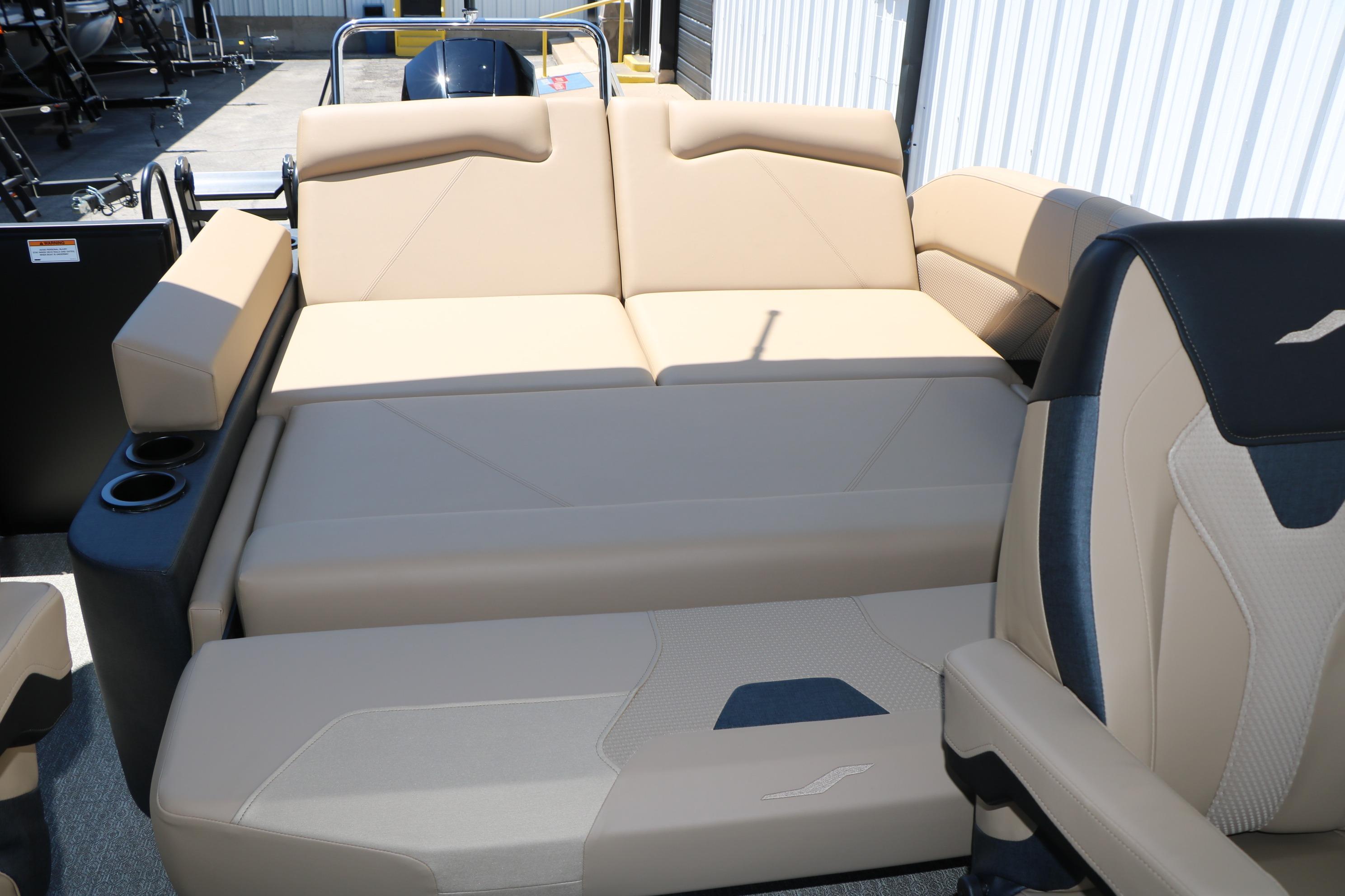 Luxurious seating on 2026 Evotti 521CS boat, featuring beige upholstery and cup holders.