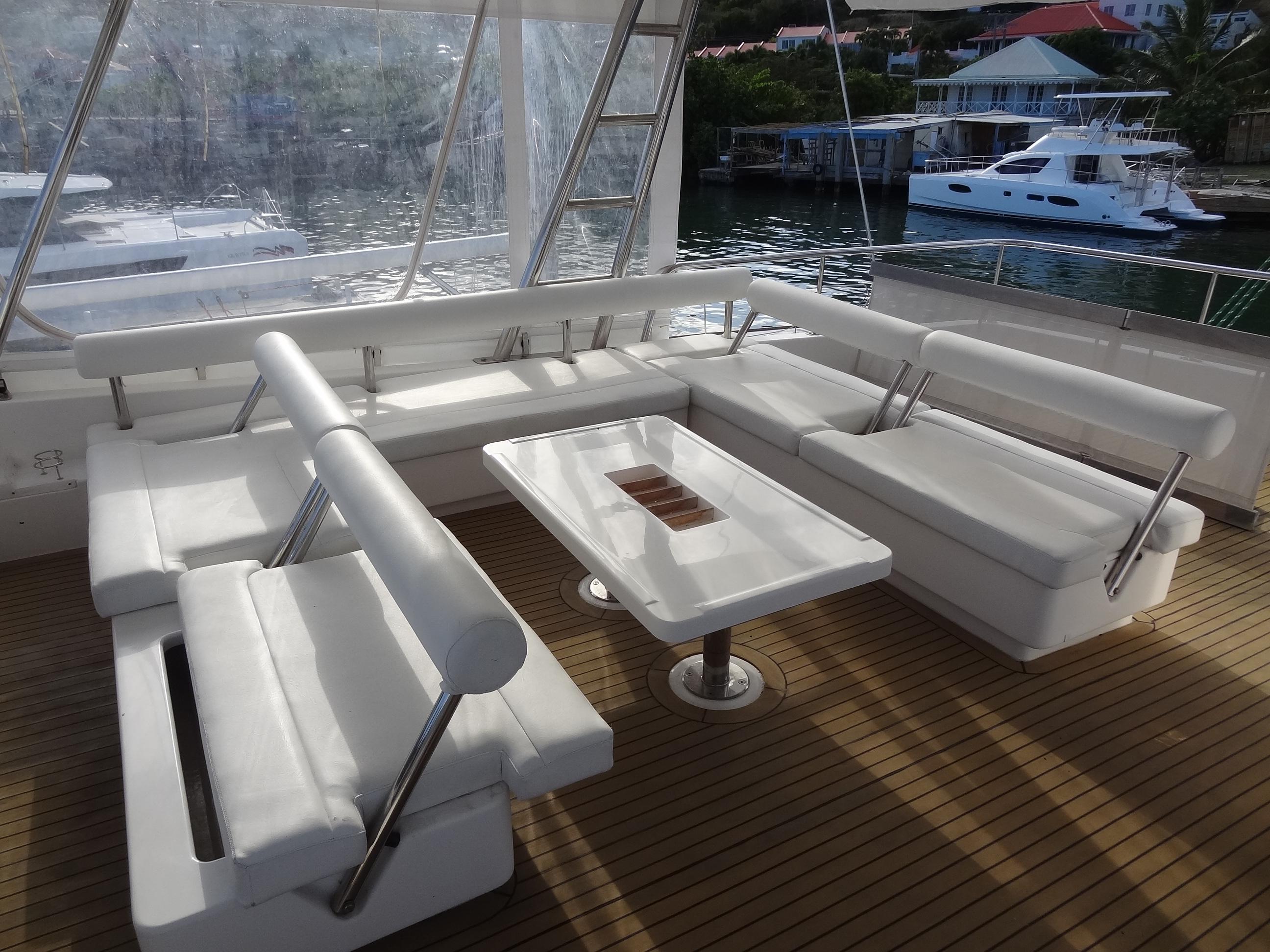 Luxurious seating area on a 2014 Leopard 58 yacht with waterfront view.