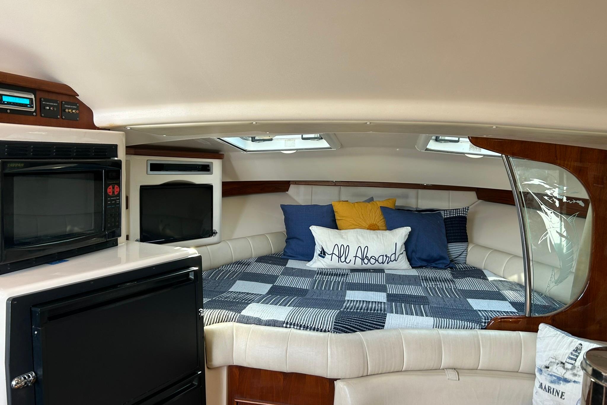 2007 Grady-White Express 360 cabin interior with bed, microwave, and TV.