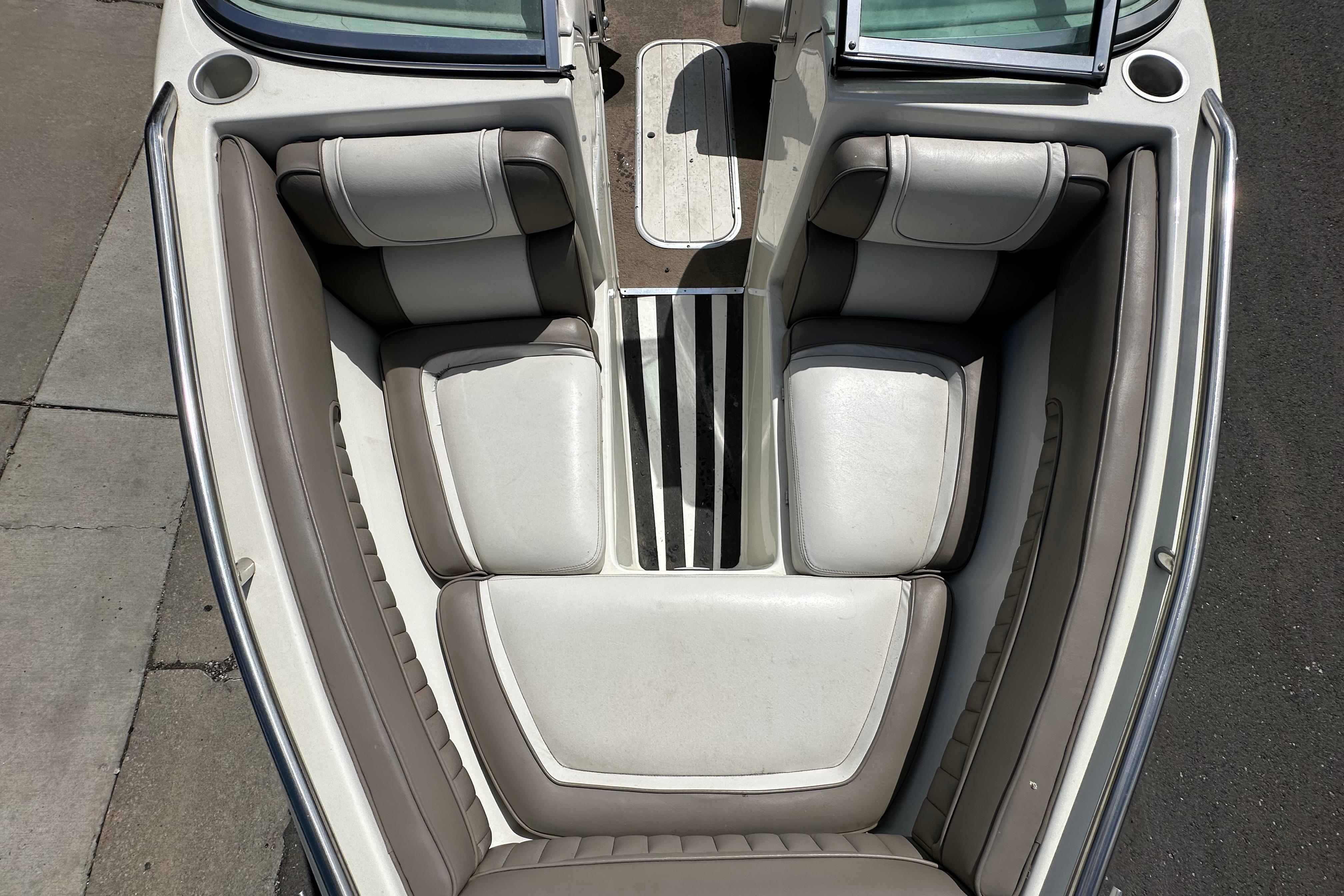 Interior view of a 1995 Mariah 180 Shabah boat, featuring cushioned seating and sleek design.