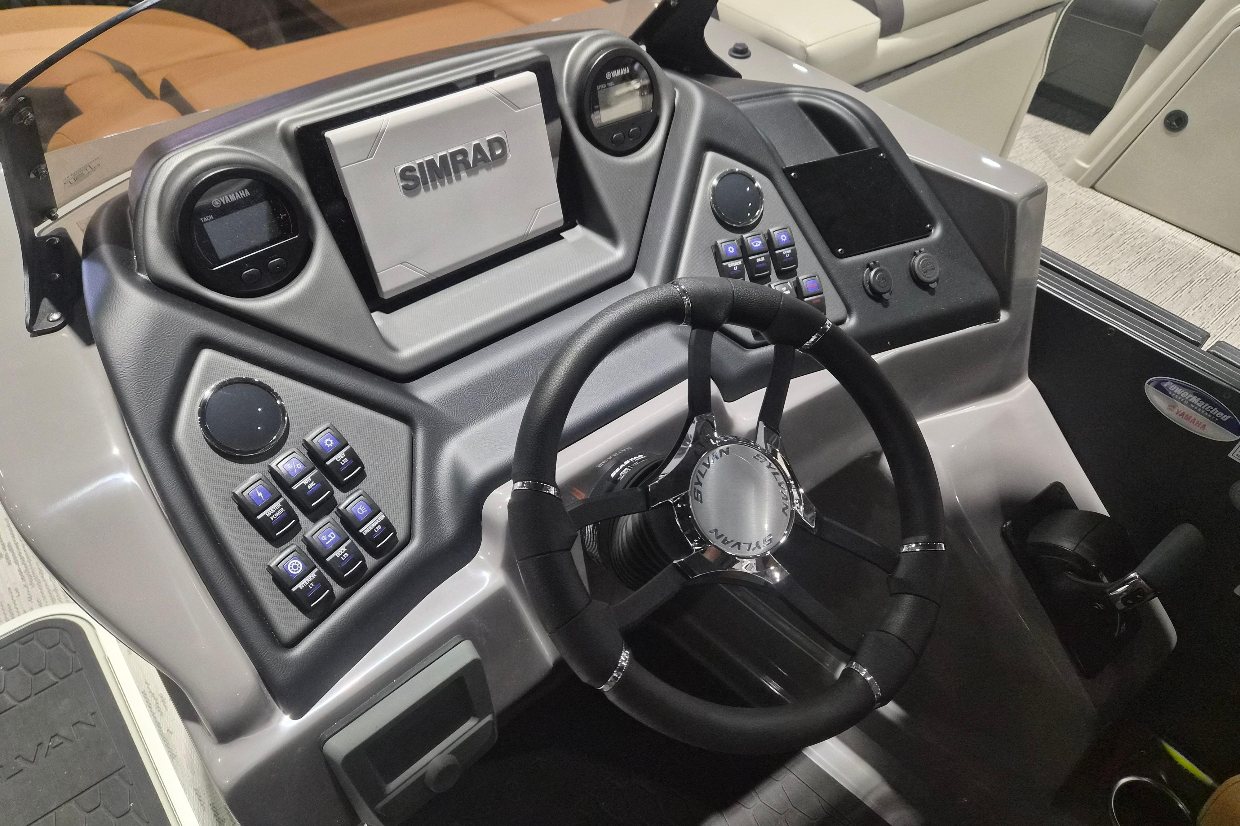 2026 Sylvan L3 SLZ boat dashboard with steering wheel and Simrad navigation system.