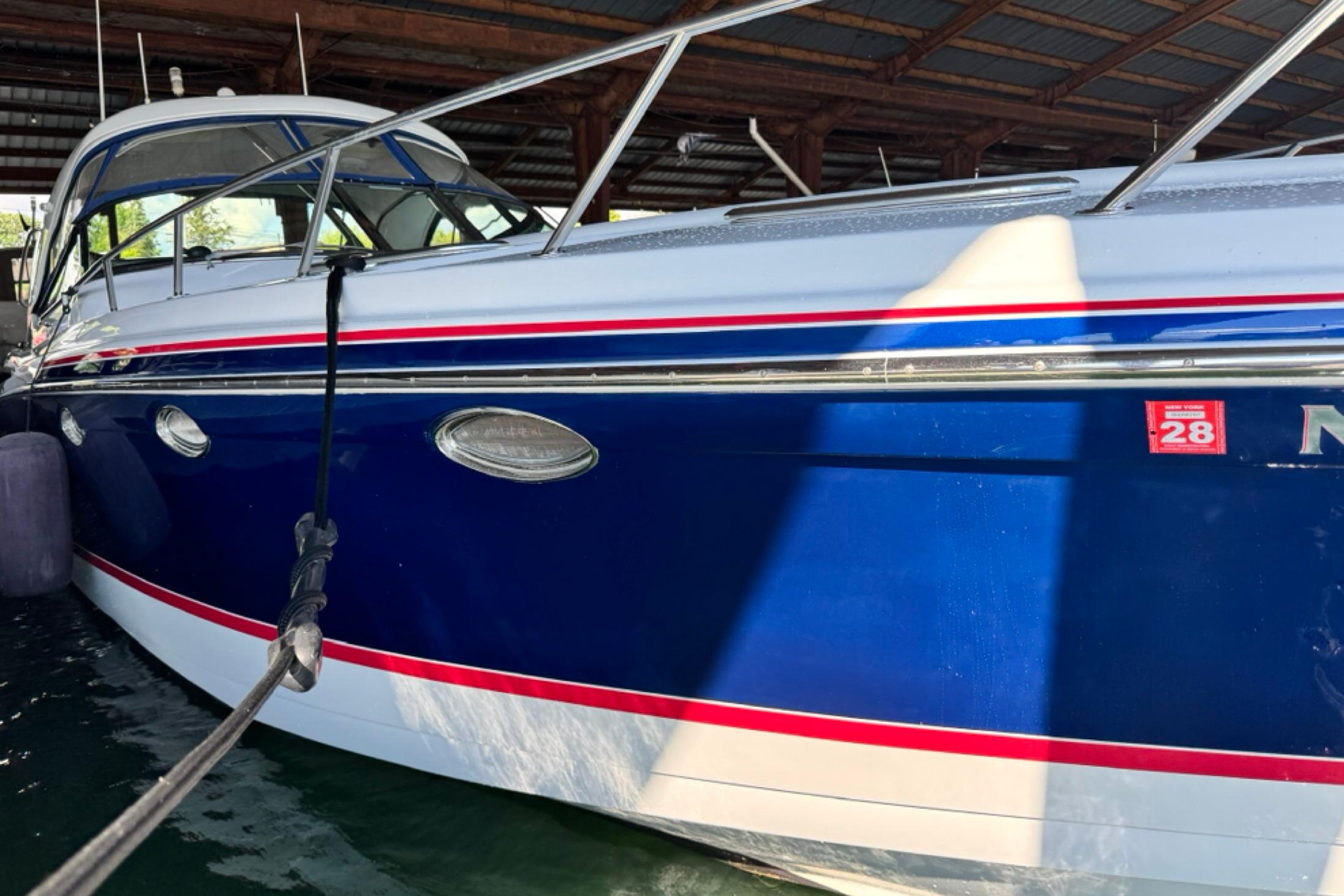 2008 Formula 400 Super Sport boat docked in a covered marina.