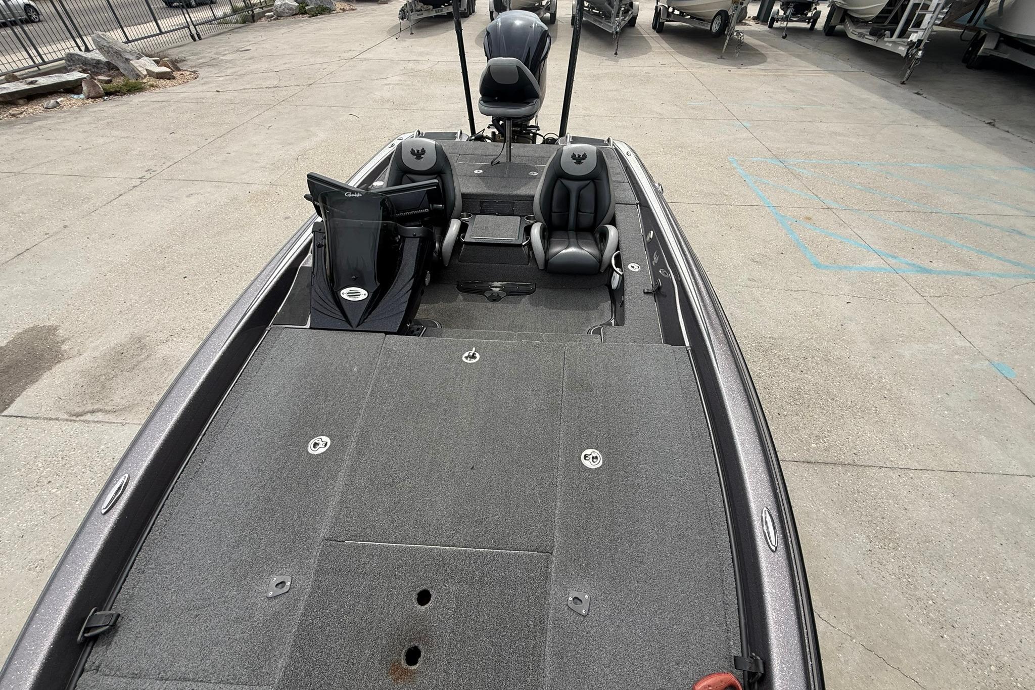 2018 Phoenix 919 ProXP boat with spacious deck and dual seating in a parking area.
