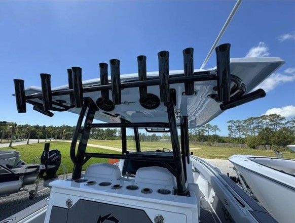 Fountain 38 Tournament Edition 2023 with fishing rod holders, blue sky background.