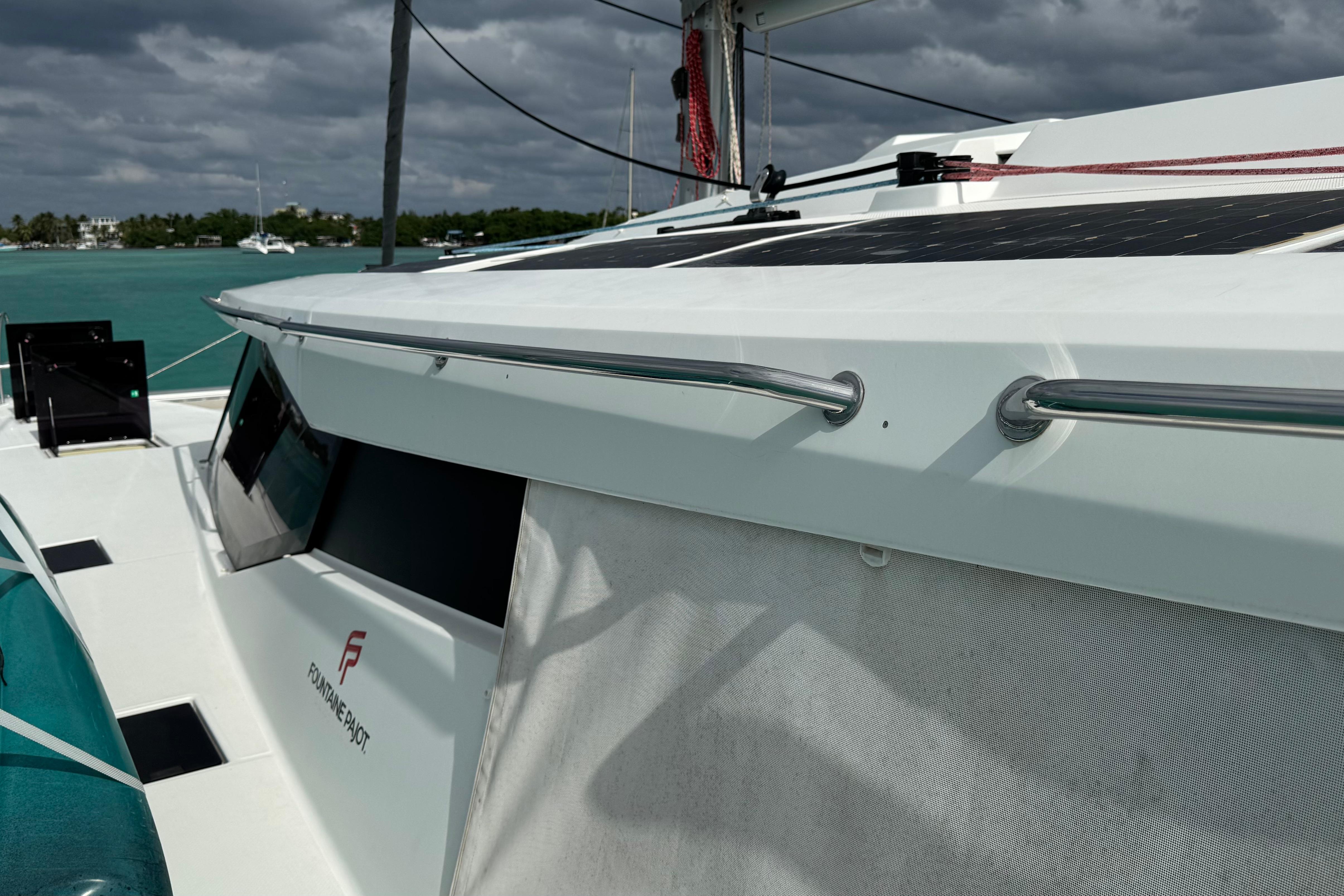 2020 Fountaine Pajot Saona 47 catamaran on turquoise water under cloudy skies.