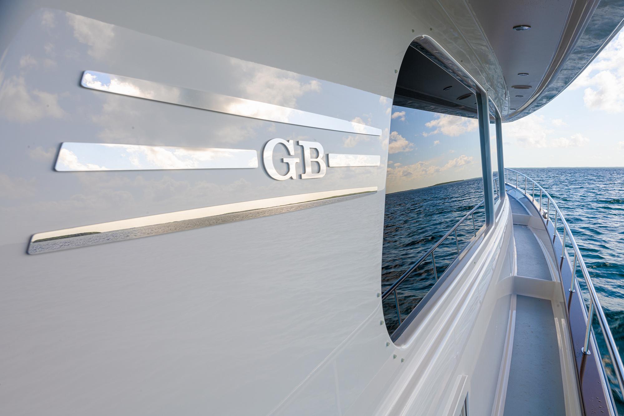 2026 Grand Banks GB 85 yacht cruising on open water, sleek design and ocean reflection.