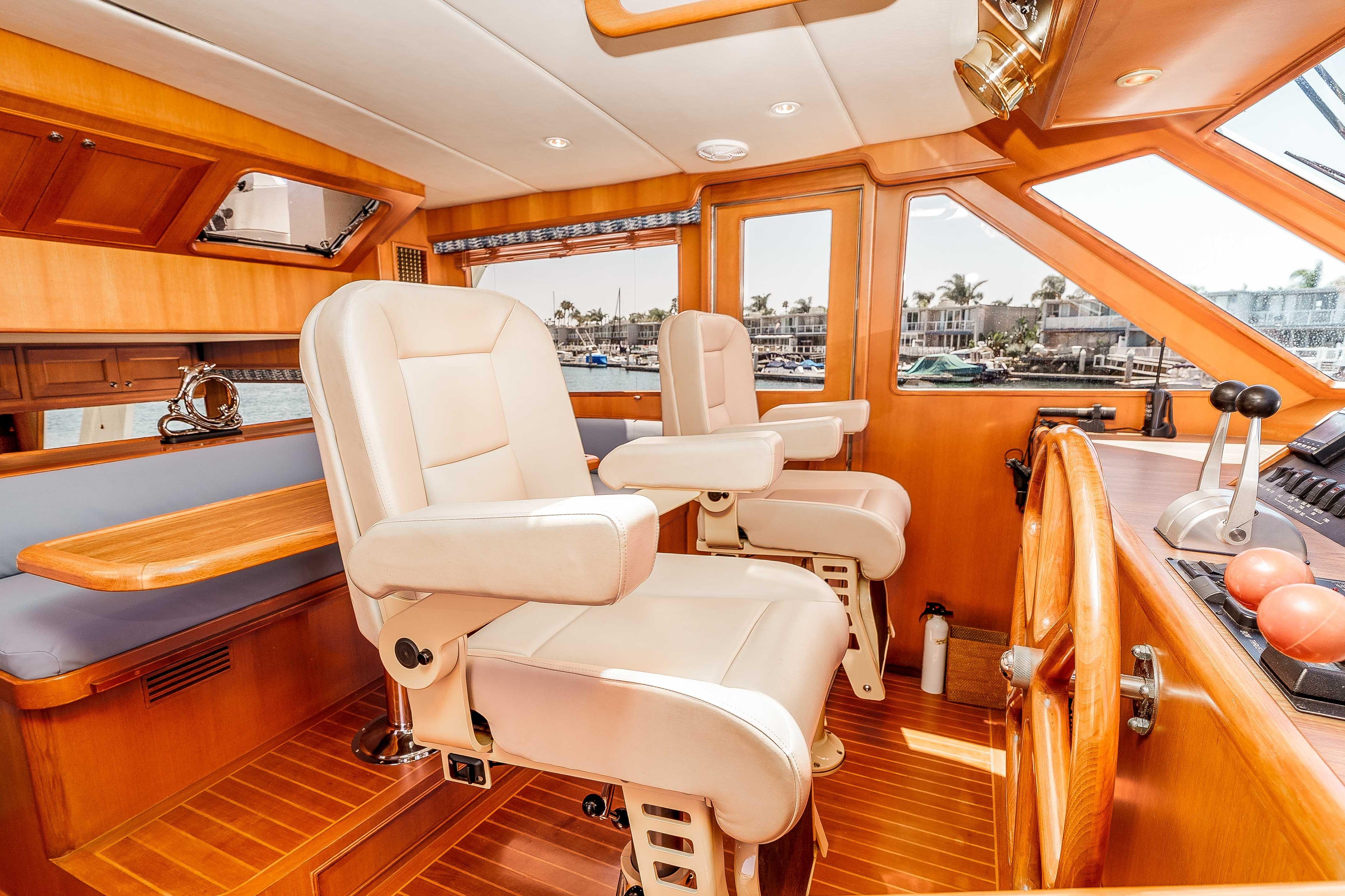 Luxurious 2005 Offshore Yachts 54 Pilothouse interior with plush seating and elegant wood finishes.