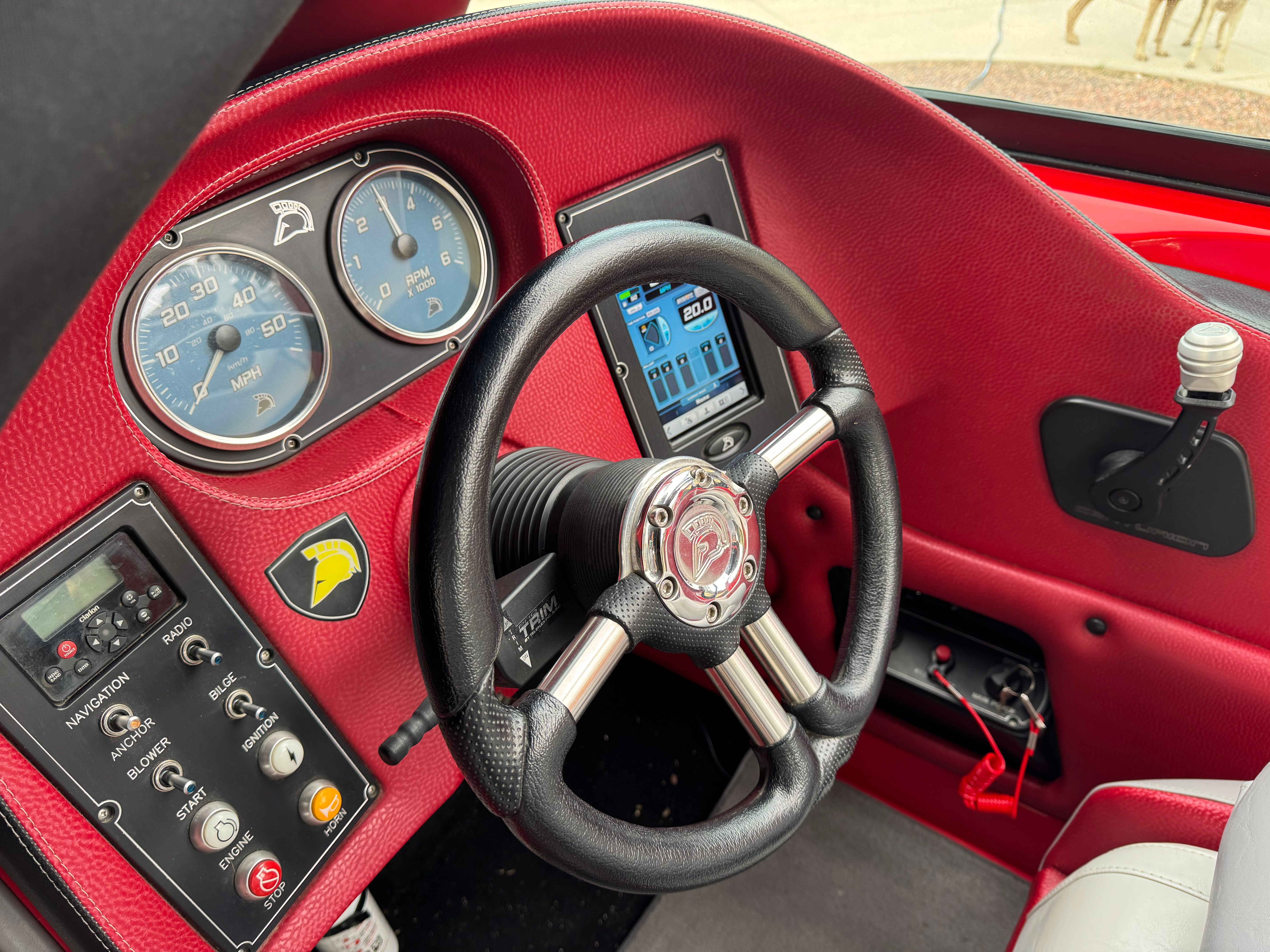 The image shows the cockpit of a 2013 Centurion Enzo SV211 with a red dashboard and modern instruments.