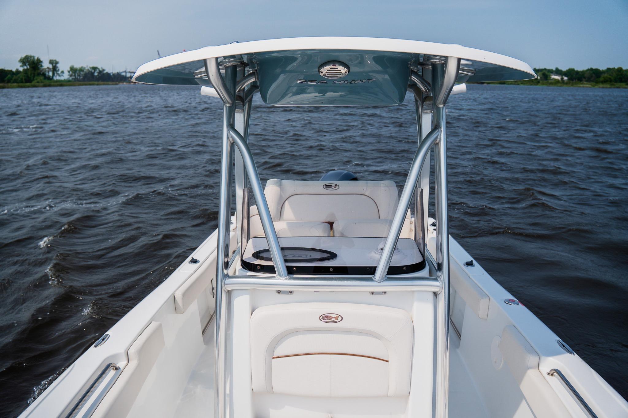 2022 Sea Hunt Ultra 229 boat on water, featuring sleek design and spacious seating.