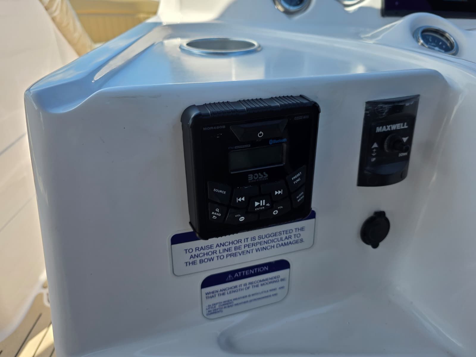Close-up of a boat console with an audio system and anchoring instructions.